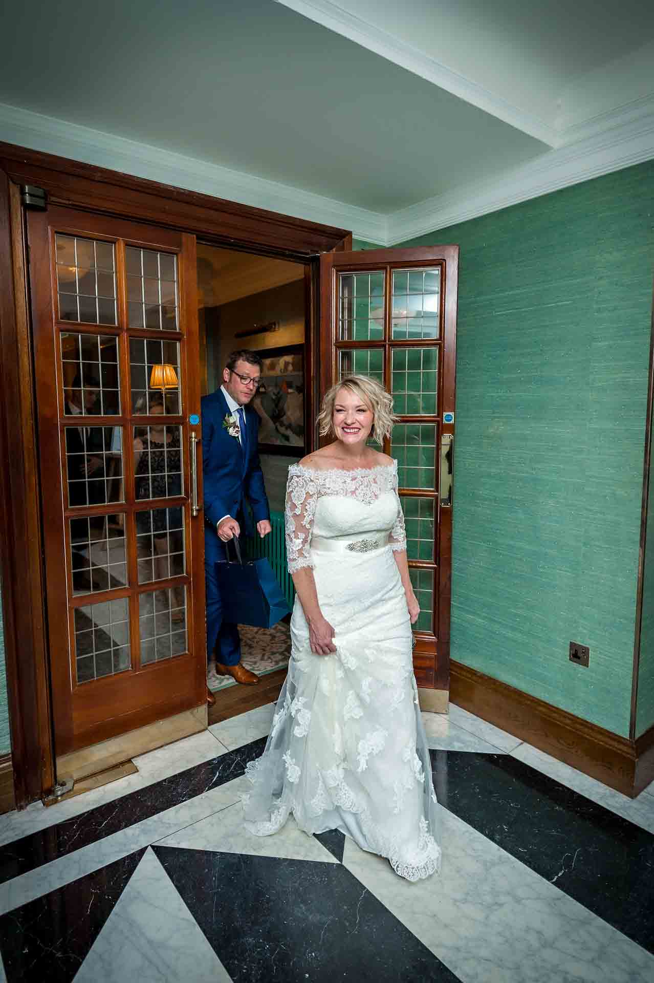 Bride and groom walking through foyer at the Bloomsbury Hotel