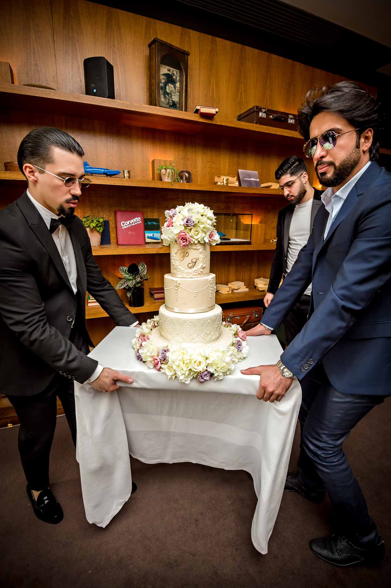 Groom and Best Man Carrying Wedding Cake