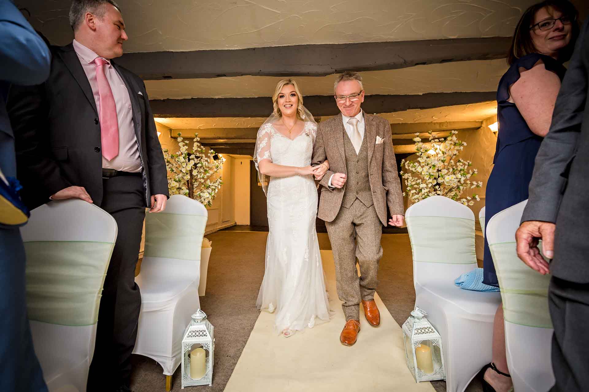 The bride and father walk down aisle at Llechwen Hall Hotel