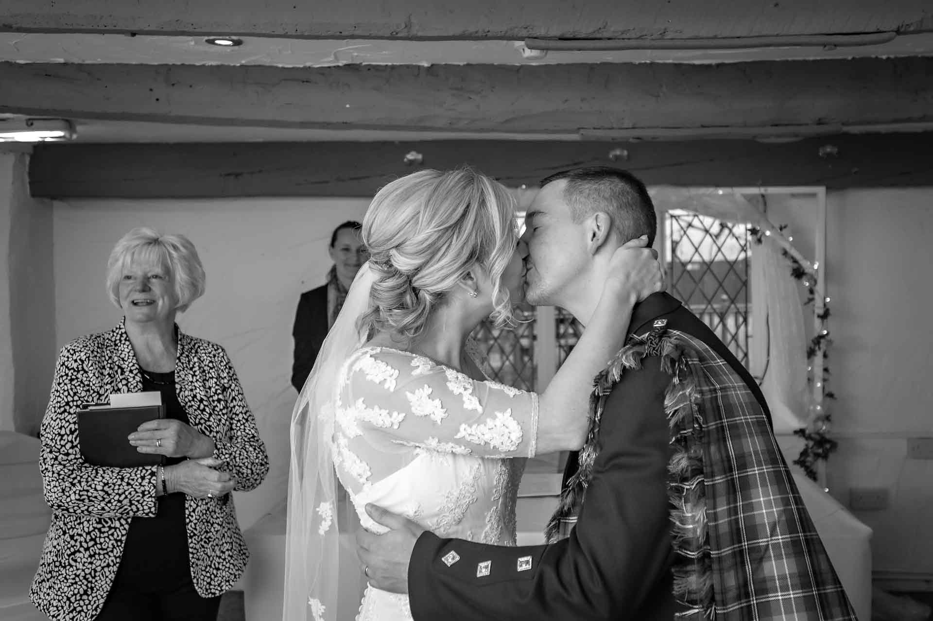 The newly-weds kiss at their wedding in the Nelson Suite of Llechwen Hall Hotel