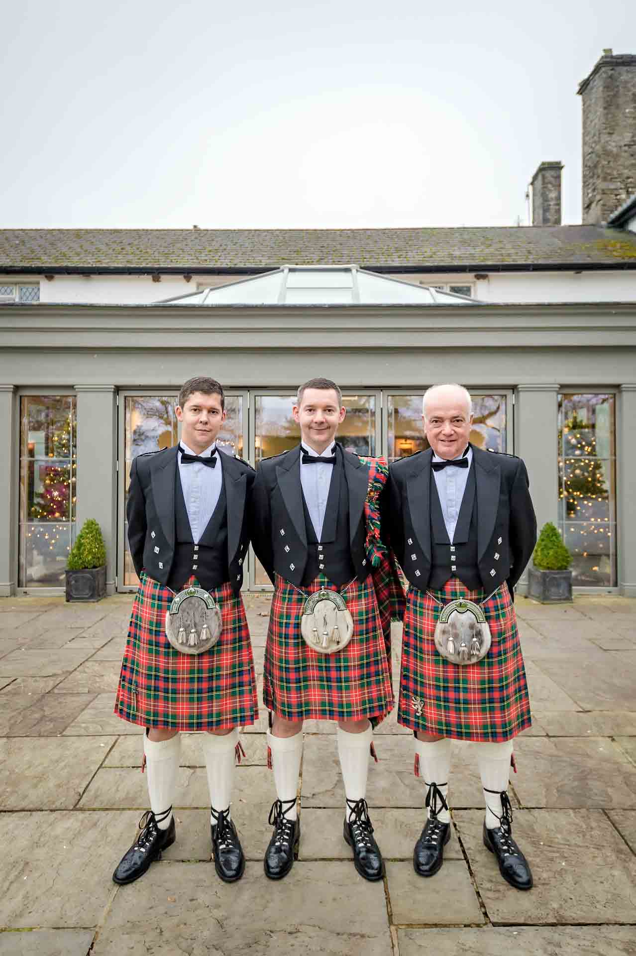 Groom with two male relatives in kilts at Llechwen Hall Hotel wedding
