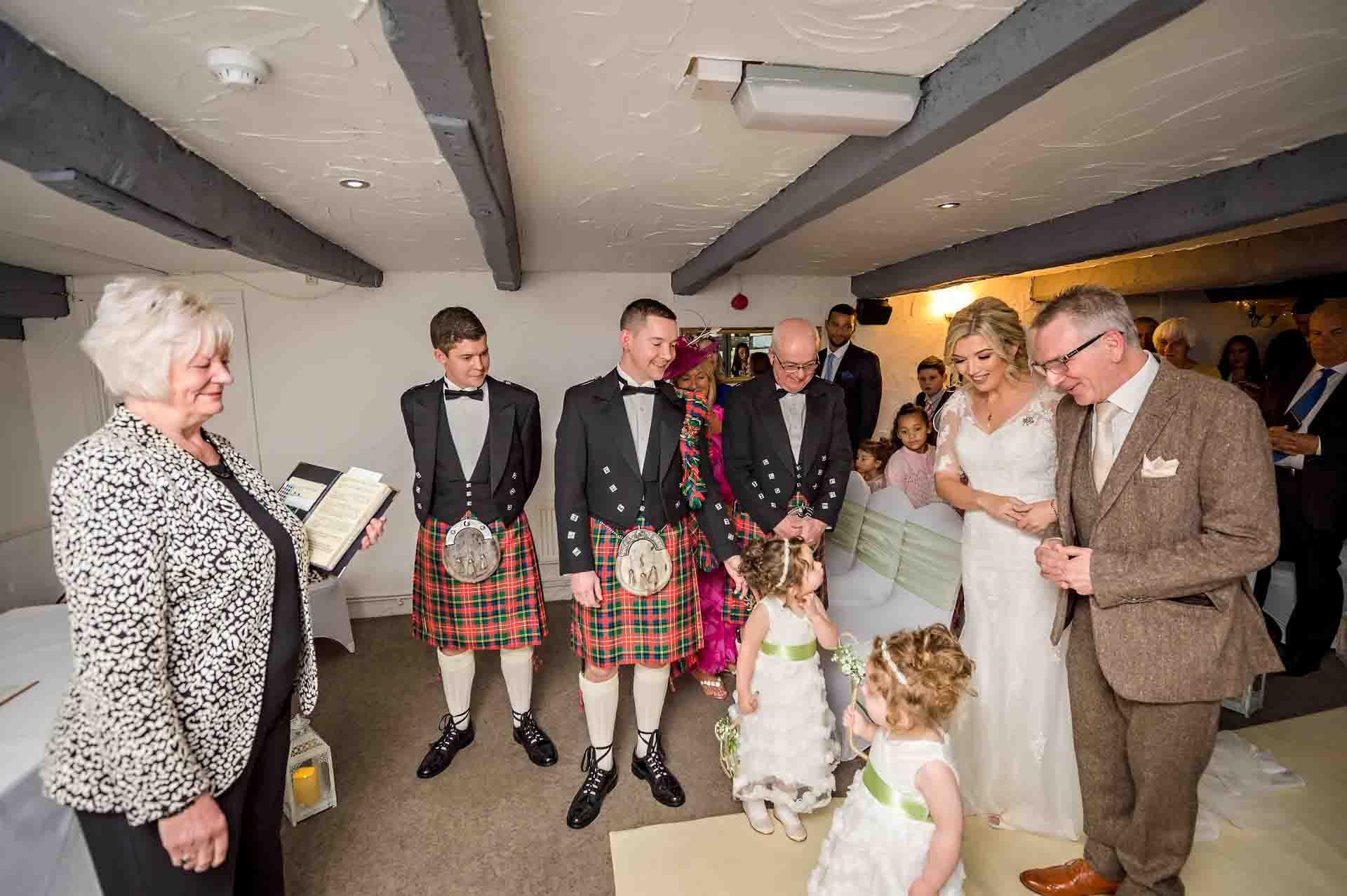 The bride reaches the 'altar' where her daughters and groom are waiting