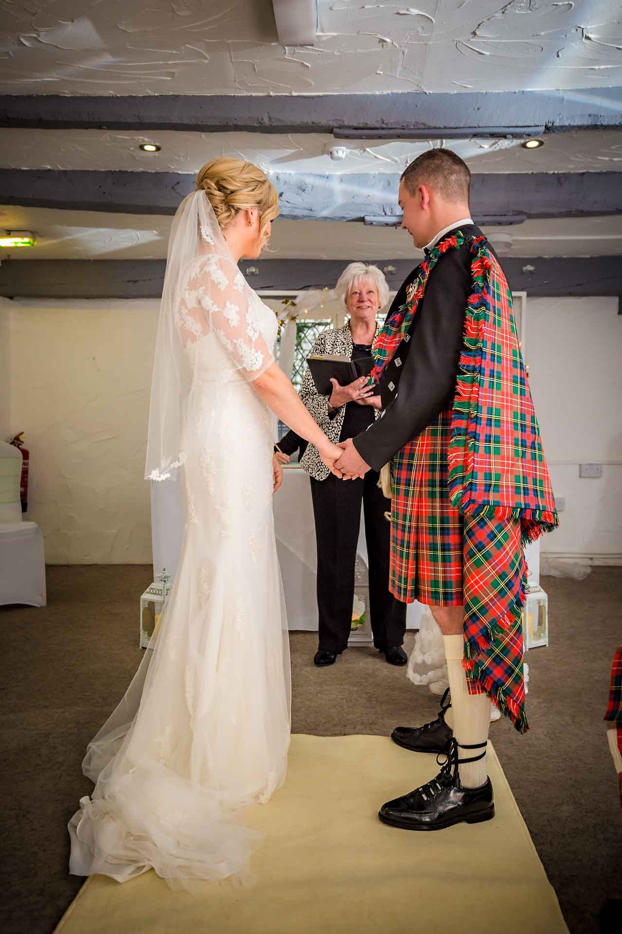 The bride and groom holding hands at wedding near Pontypridd