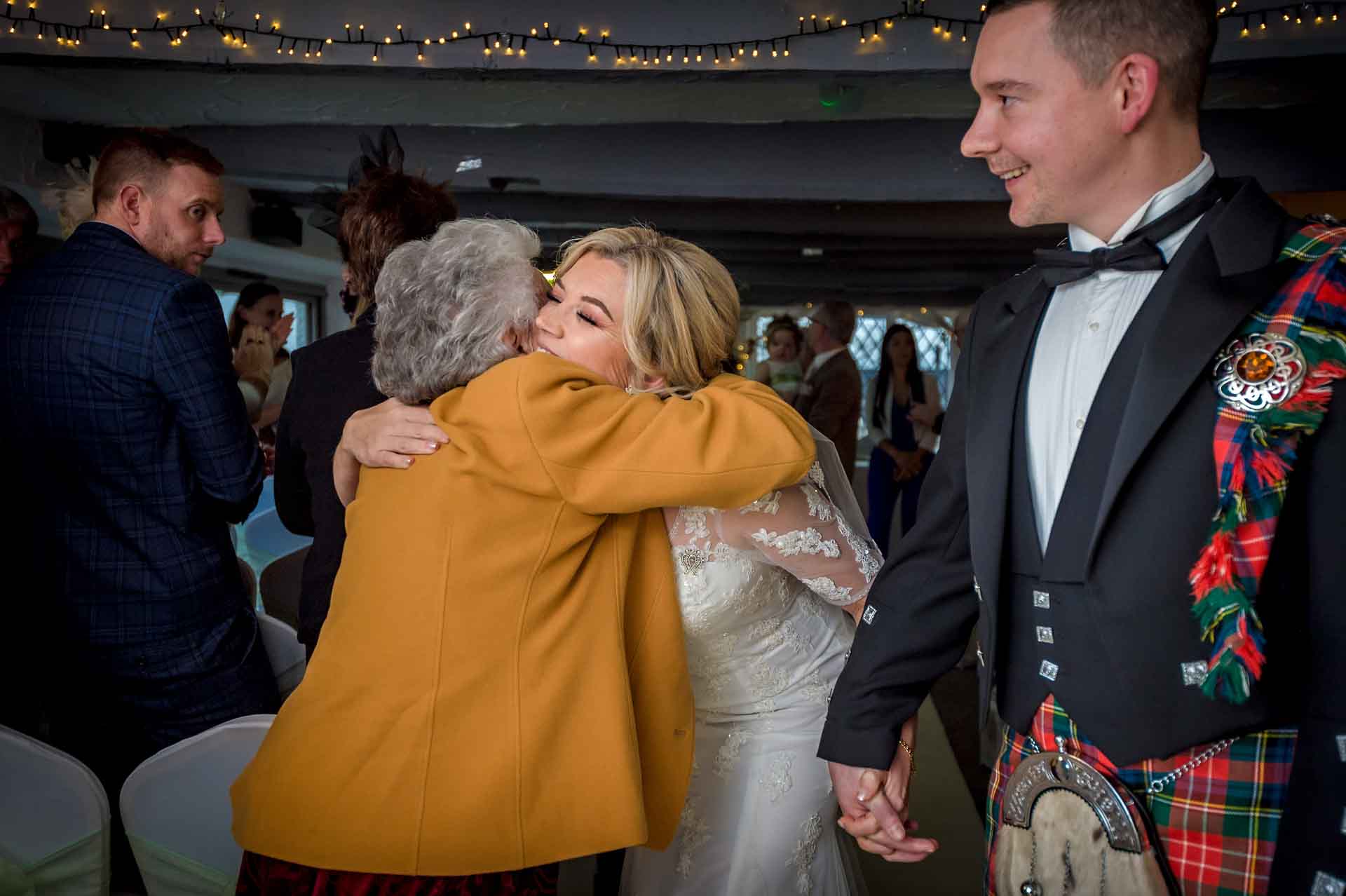 Bride's grandma hugs her in Nelson Suite of Llechwen Hall Hotel