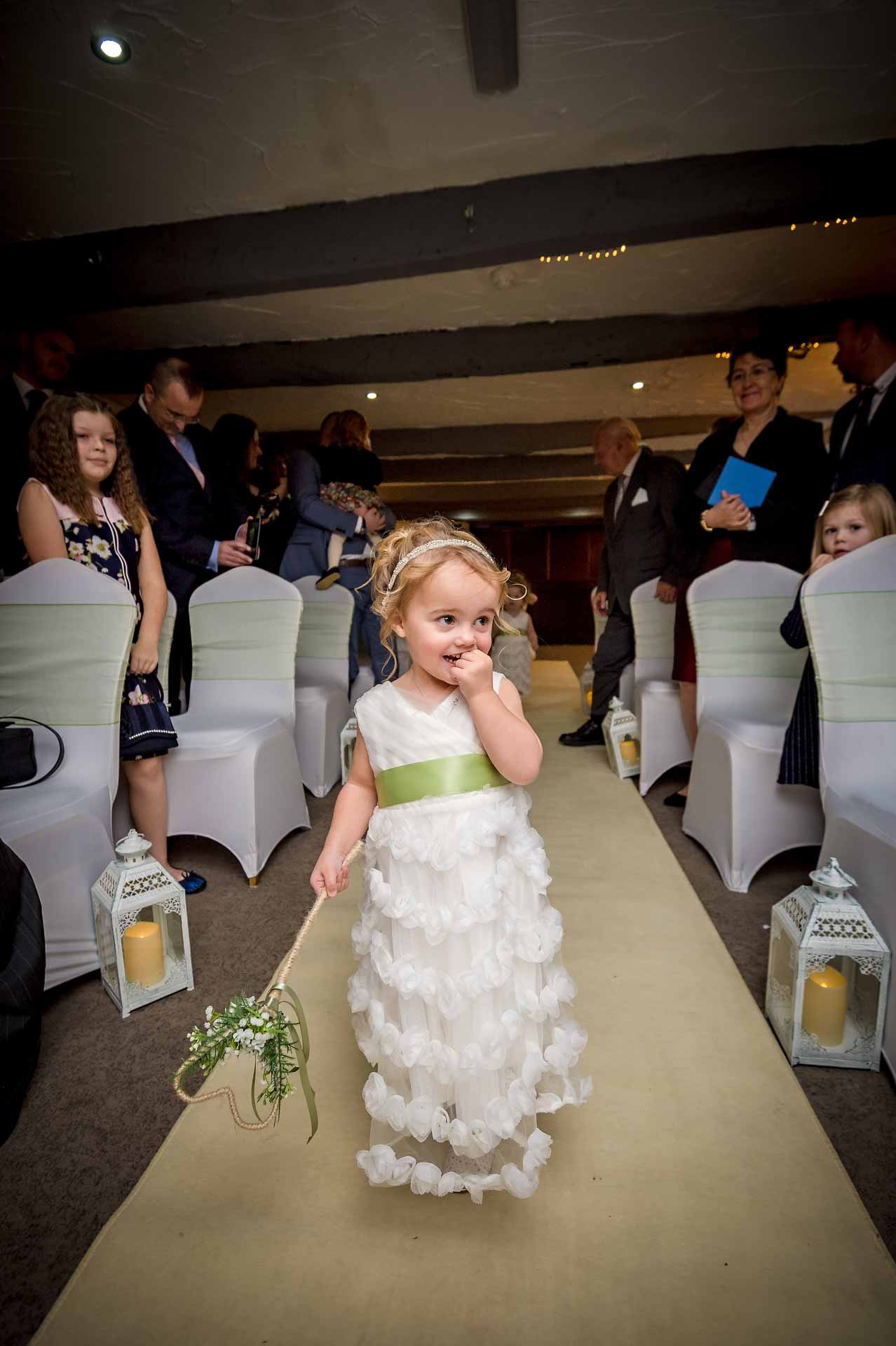 Shy bridesmaid walking down the aisle at Llechwen Hall Hotel near Caerphilly