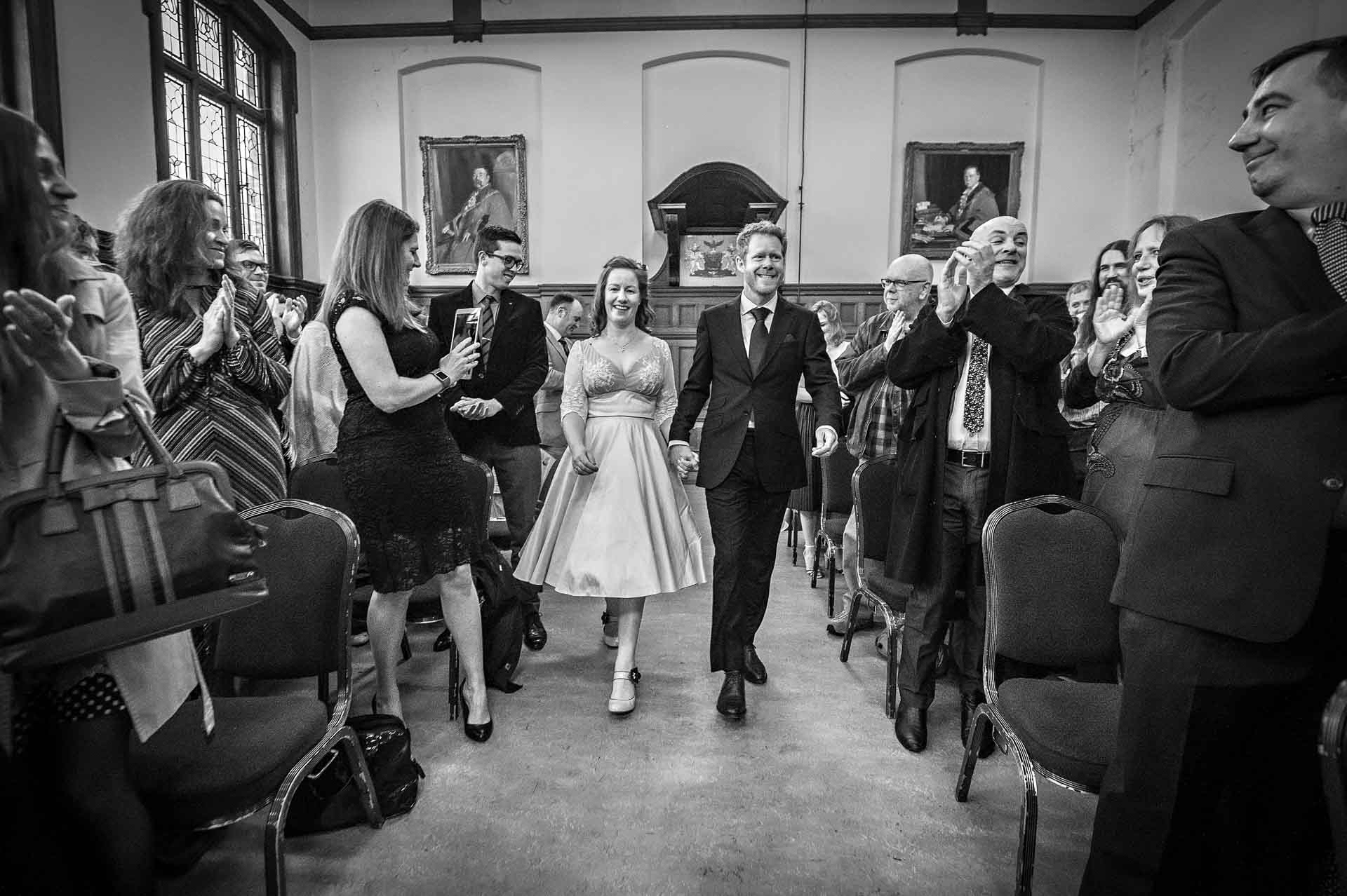 Chiswick Town Hall Wedding Photography - Bride and Groom Walk Down the Aisle