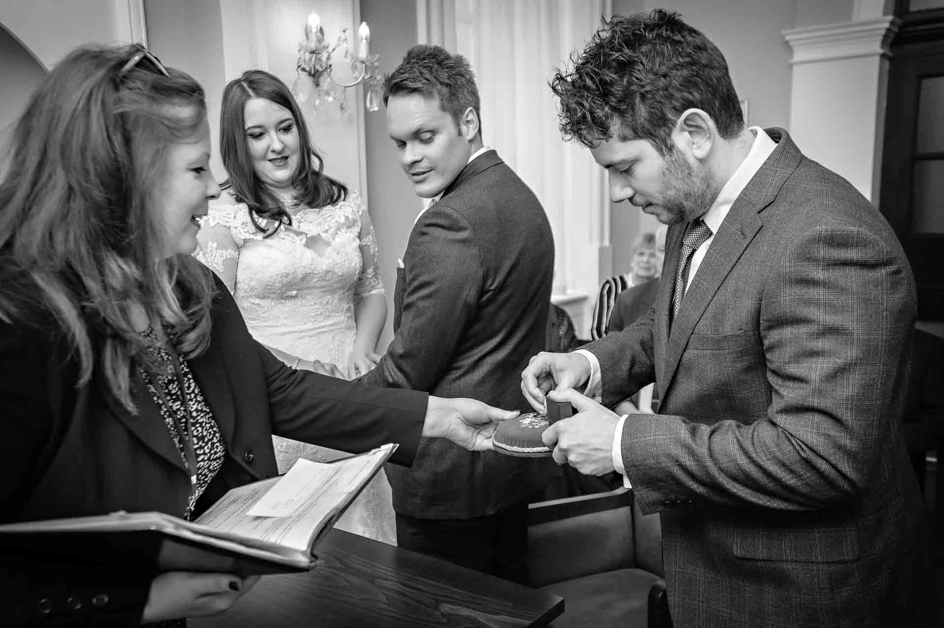 Best Man Presents Wedding Ring Whilst Bride and Groom Watch