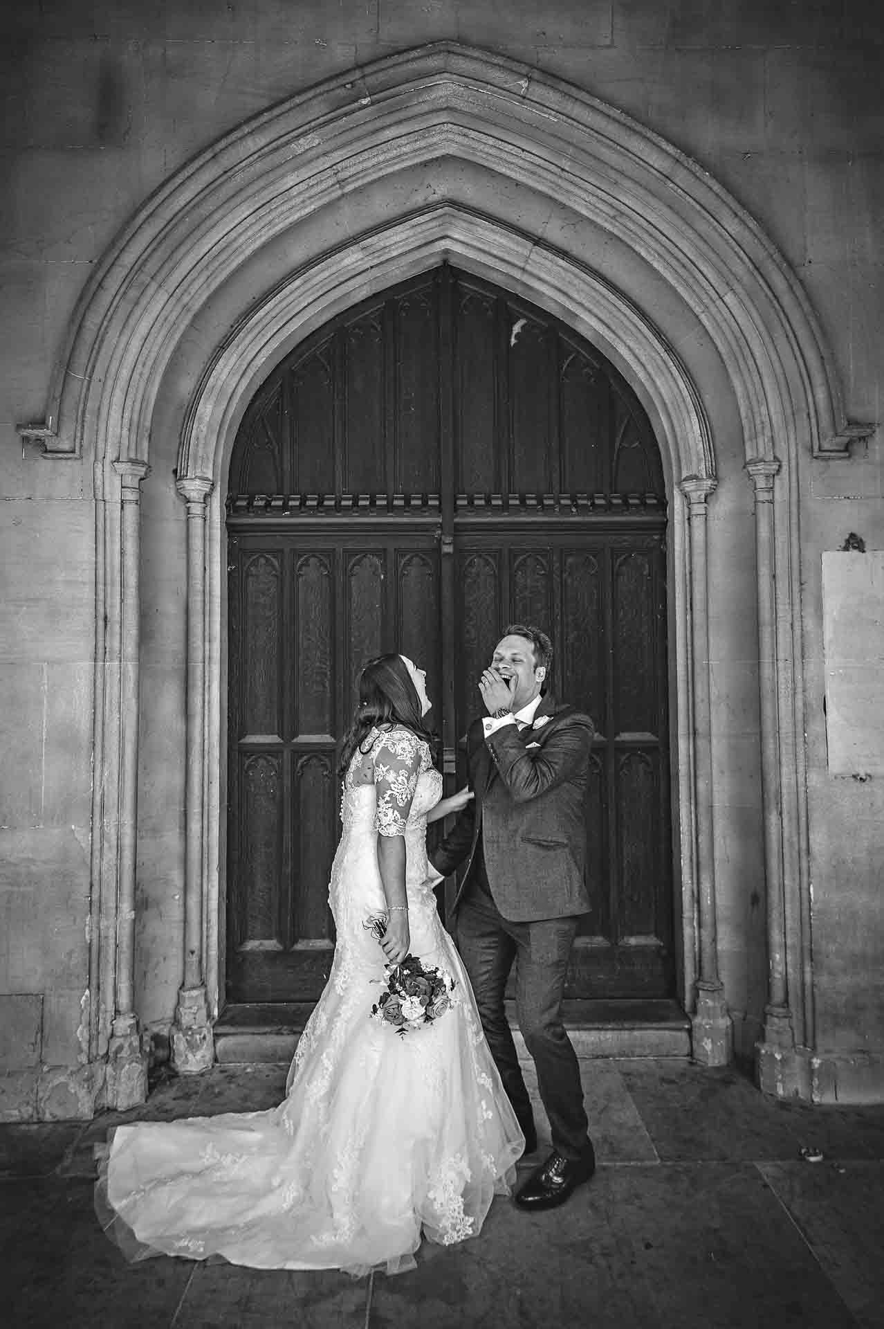 Couple laughing outside St Luke's Church in Chelsea