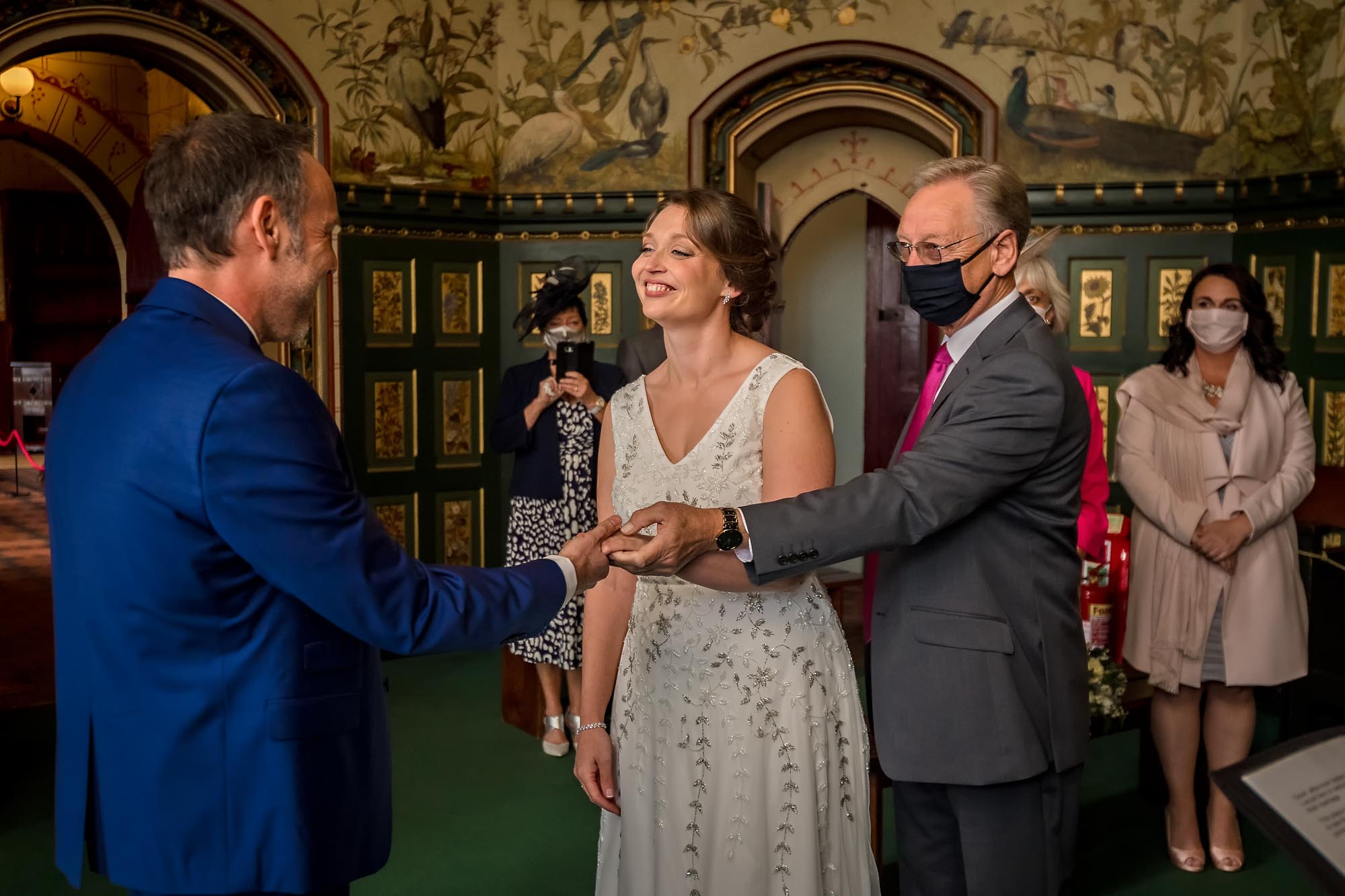 The bride's father gives her away at her wedding at Castell Coch near Cardiff