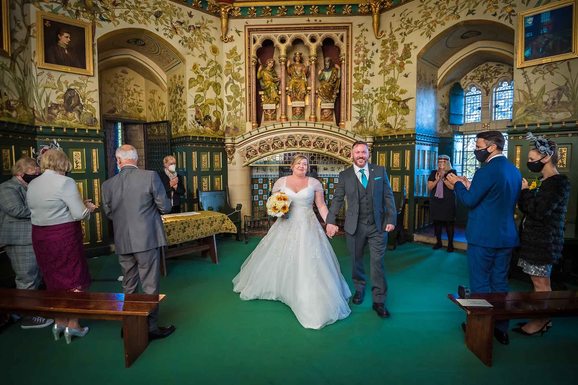The happy couple exit the Drawing Room after their wedding at Castell Coch