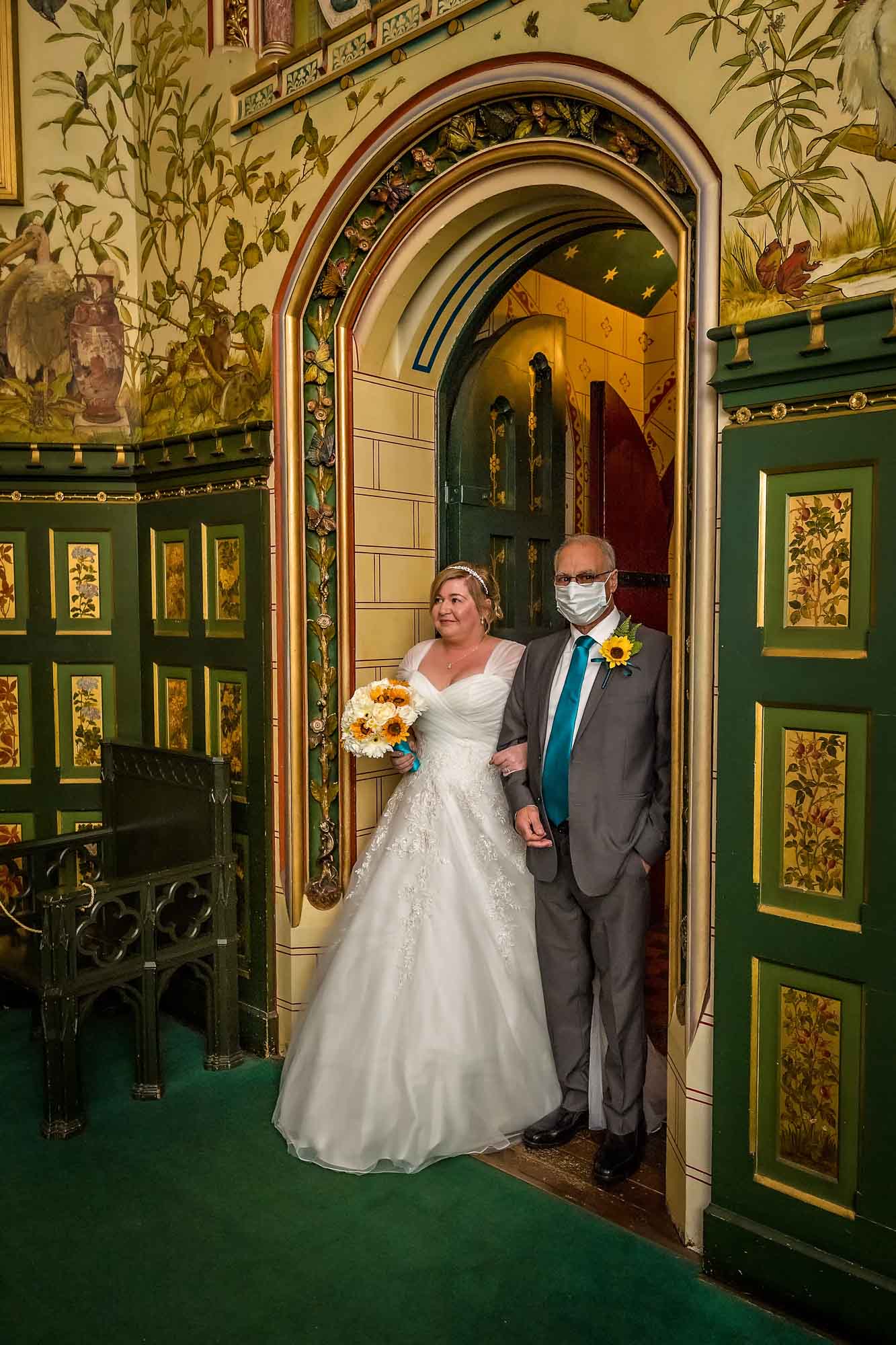 The bride enters the drawing Room at Castell Coch with her COVID-19 masked father