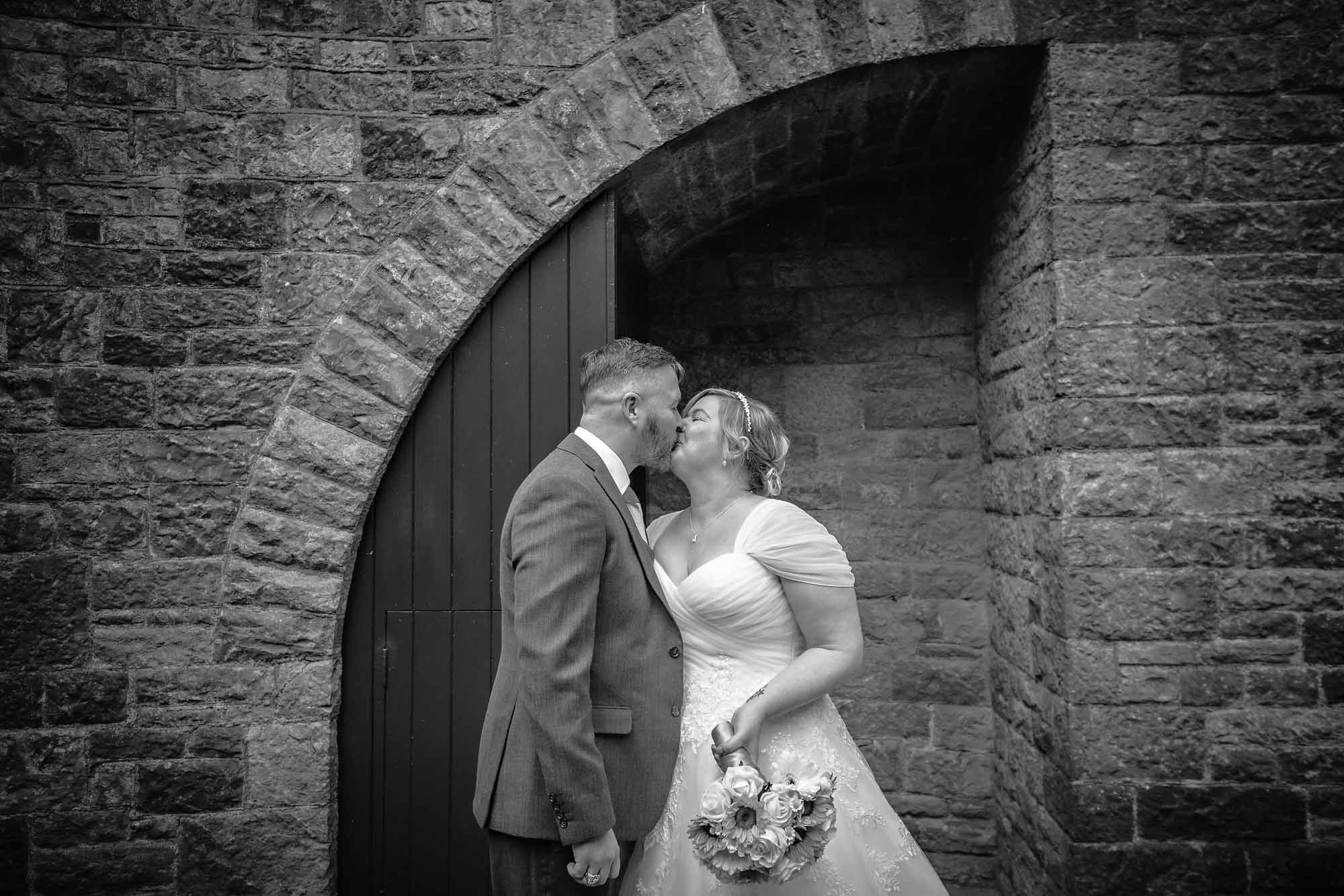 The groom kisses his bride after their ceremony at Castell Coch