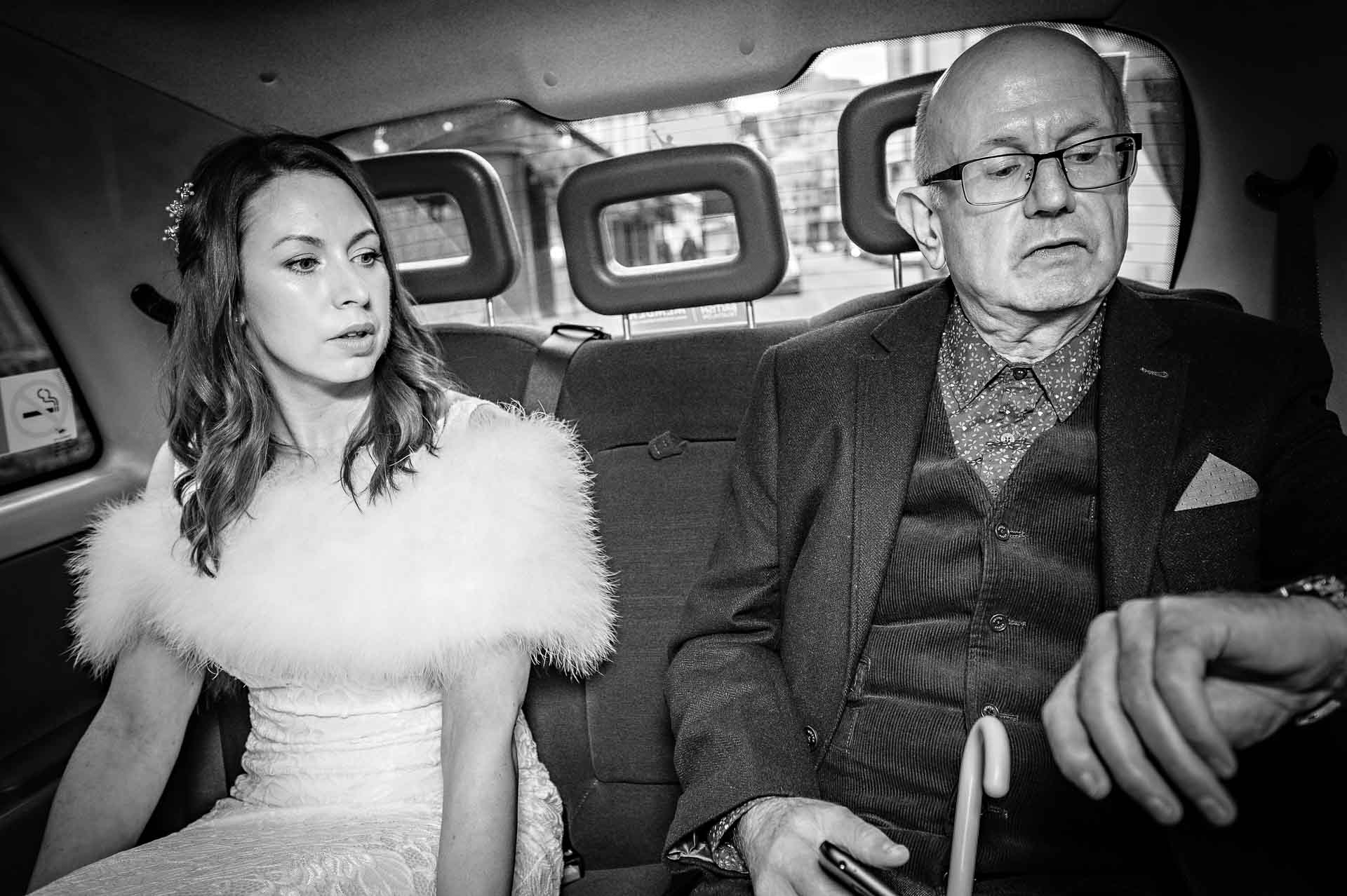 Bride and Father in London Black Taxi on way to wedding