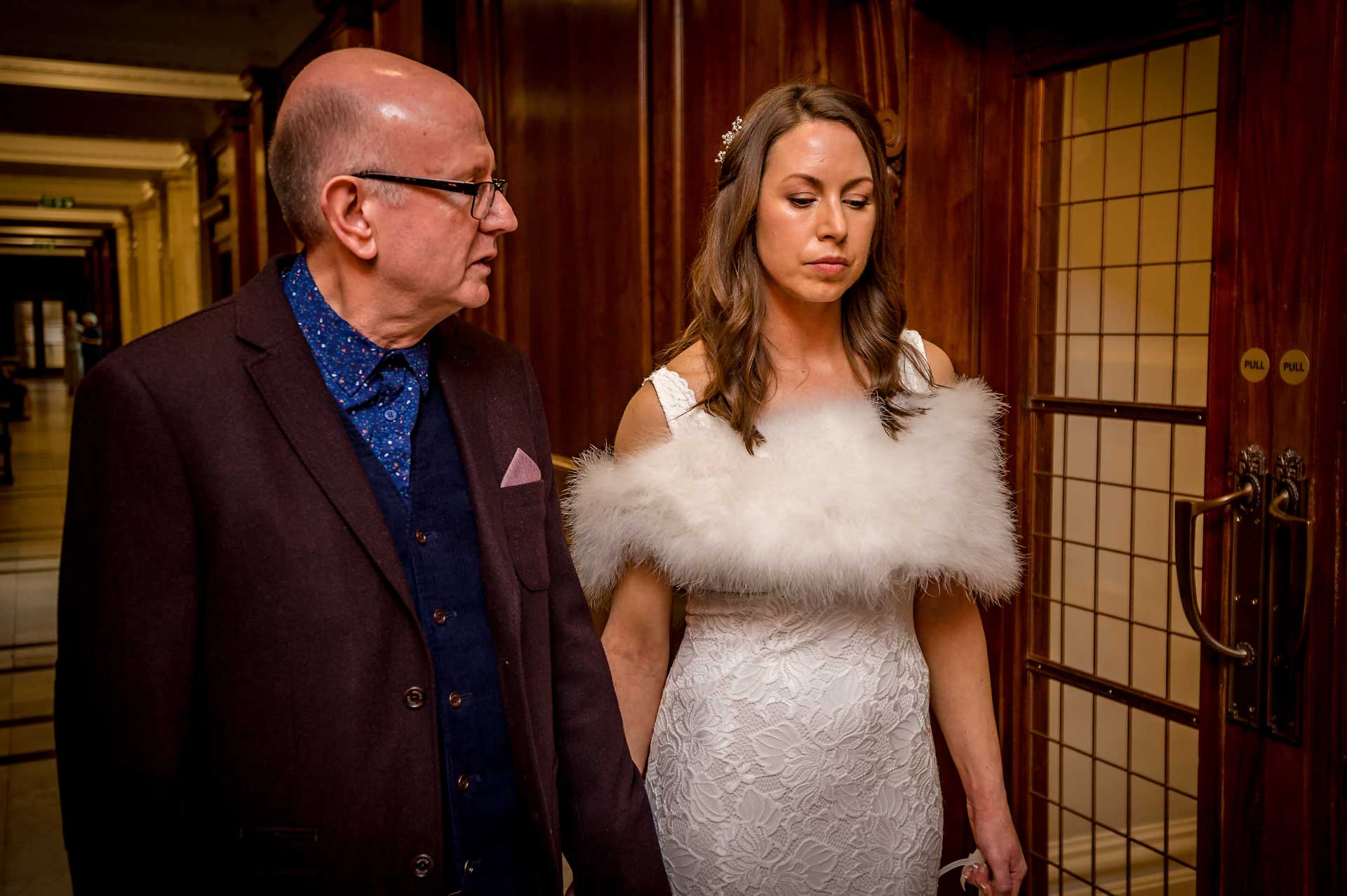Bride with dad looking thoughtful before wedding ceremony