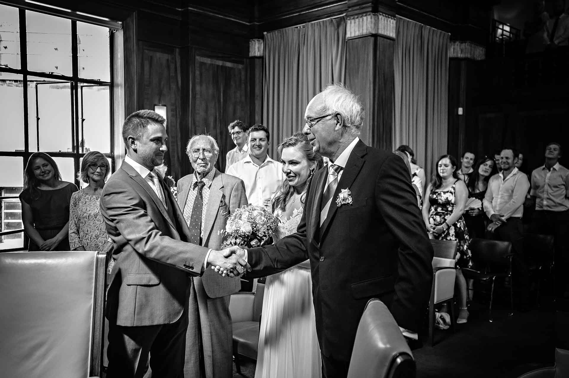 father of bride shaking groom by the hand at Stoke Newington Town Hall wedding