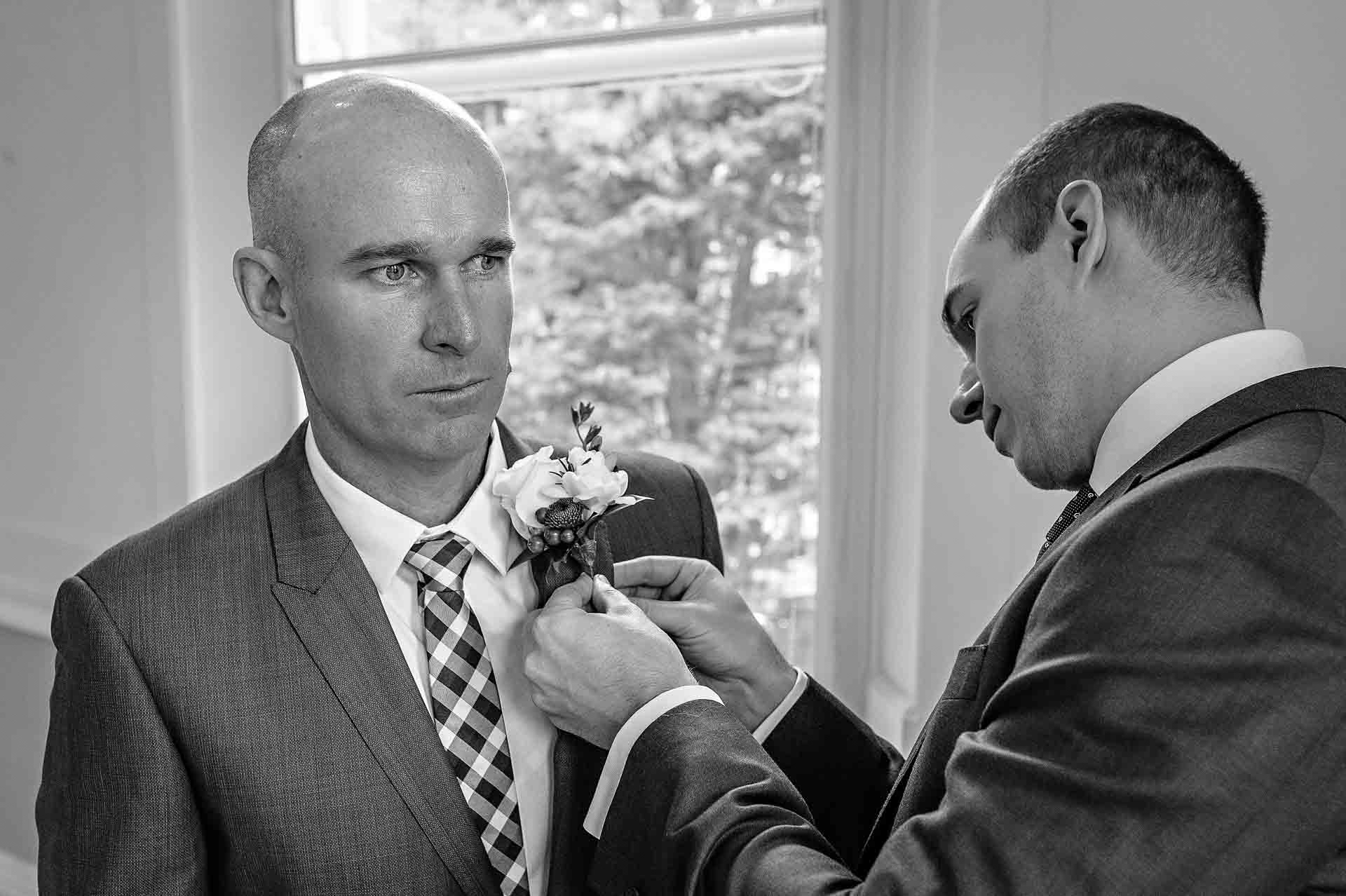 Groom having button hole attached at Cardiff wedding