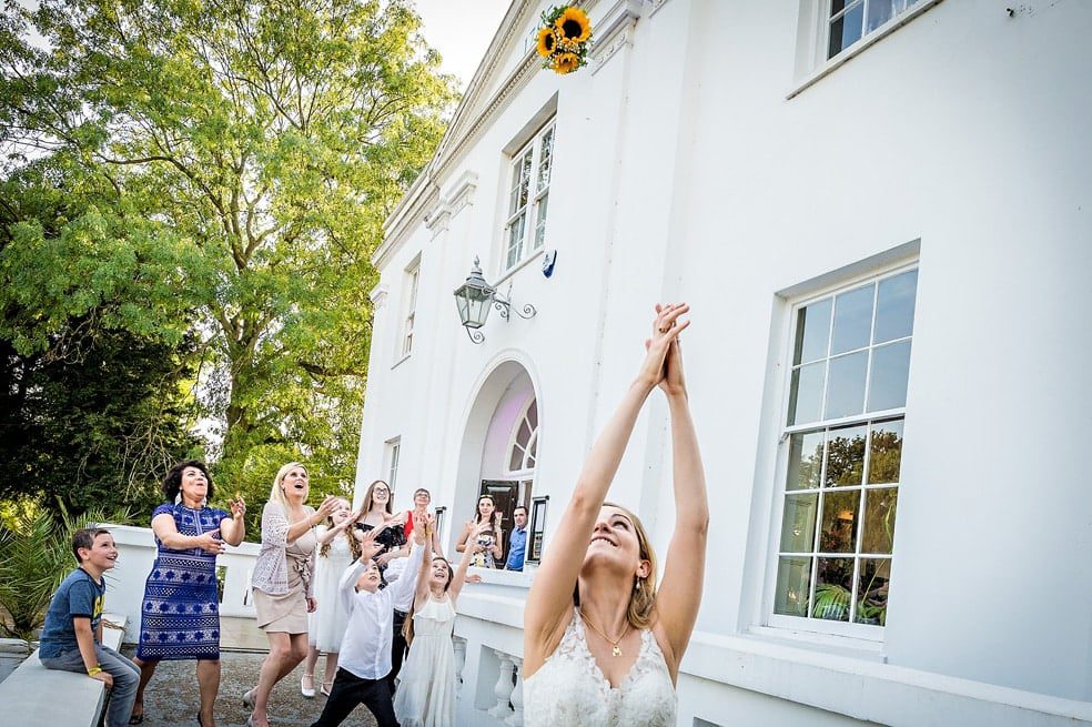 Bride tossing her wedding bouquet at Belair House in Dulwich