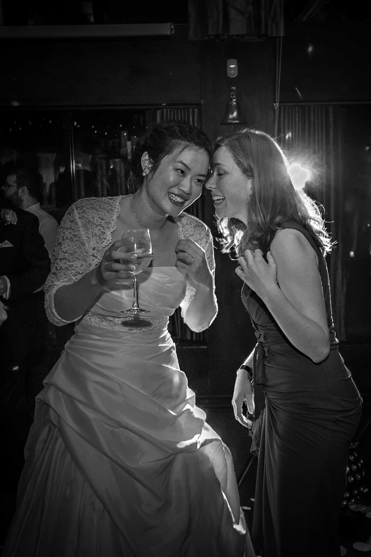 Chinese bride laughing with wedding guest