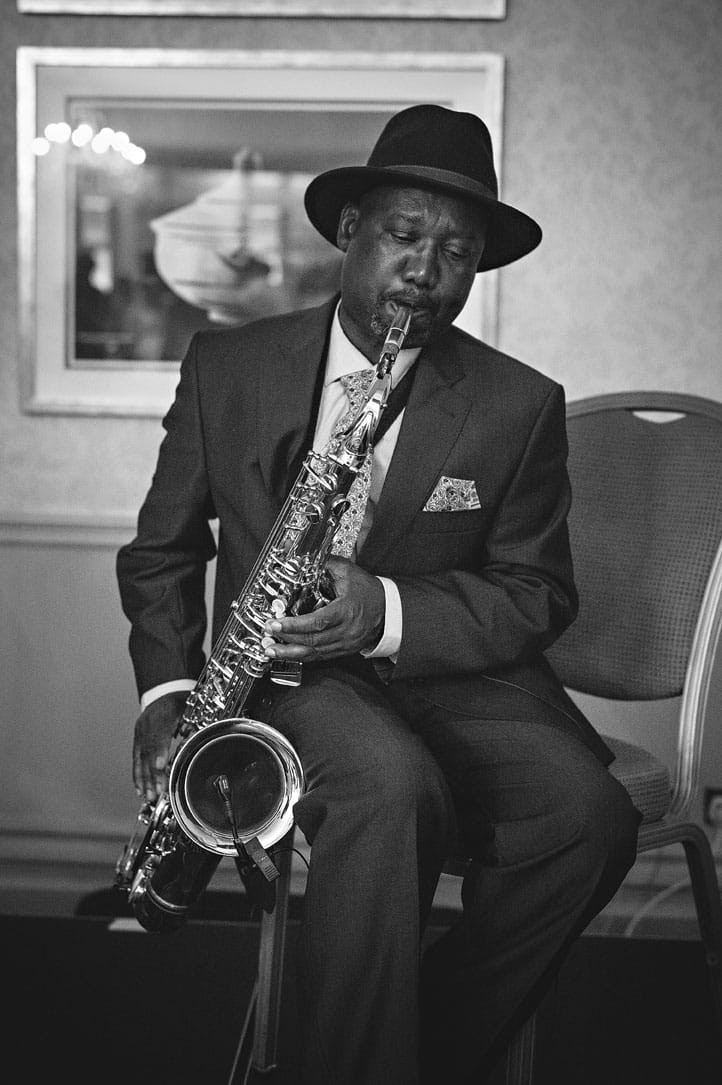 Black and white shot of saxophone player playing at wedding