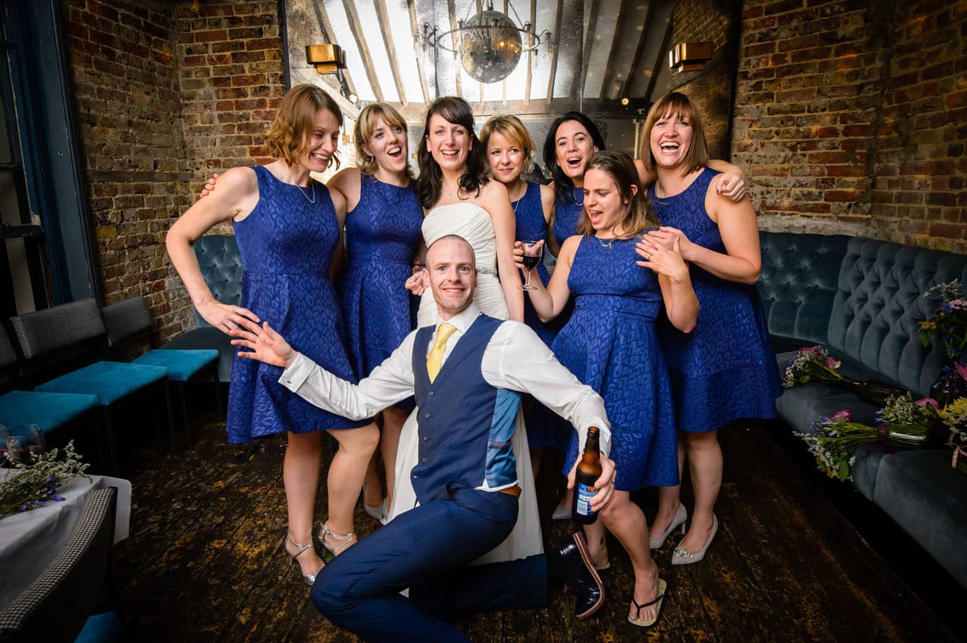 Groom in front of bride and bridesmaids at London wedding