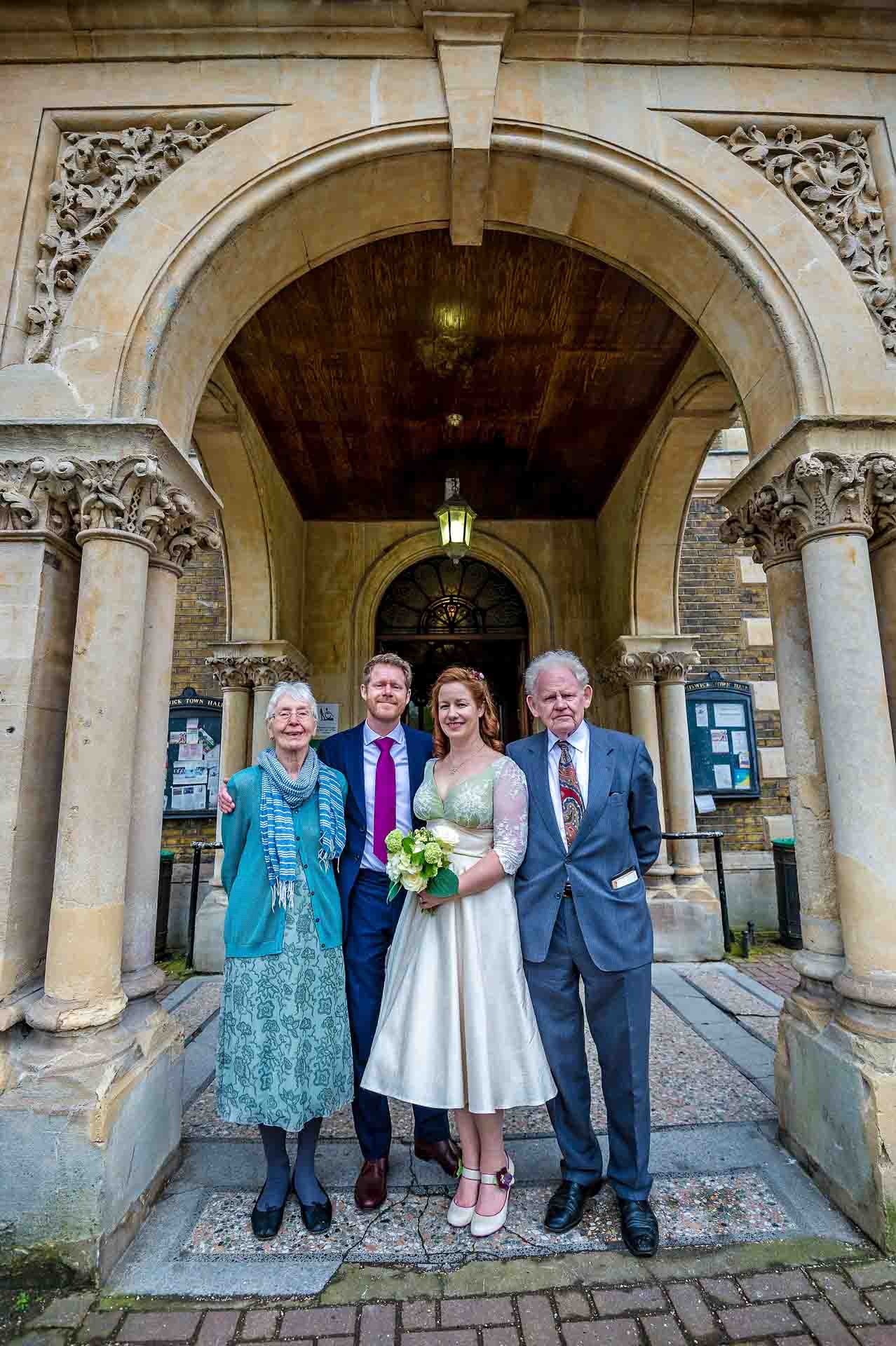 Wedded Couple with Bride's Parents in front of Portico at Chiswick Town Hall