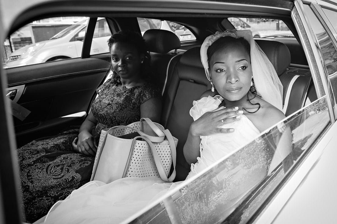 Bride and bridesmaid wait in car on arrival at wedding ceremony