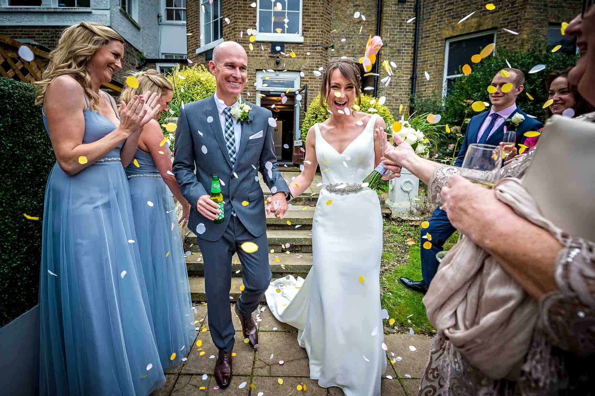 Confetti being thrown on newly-weds in garden of Winchester House