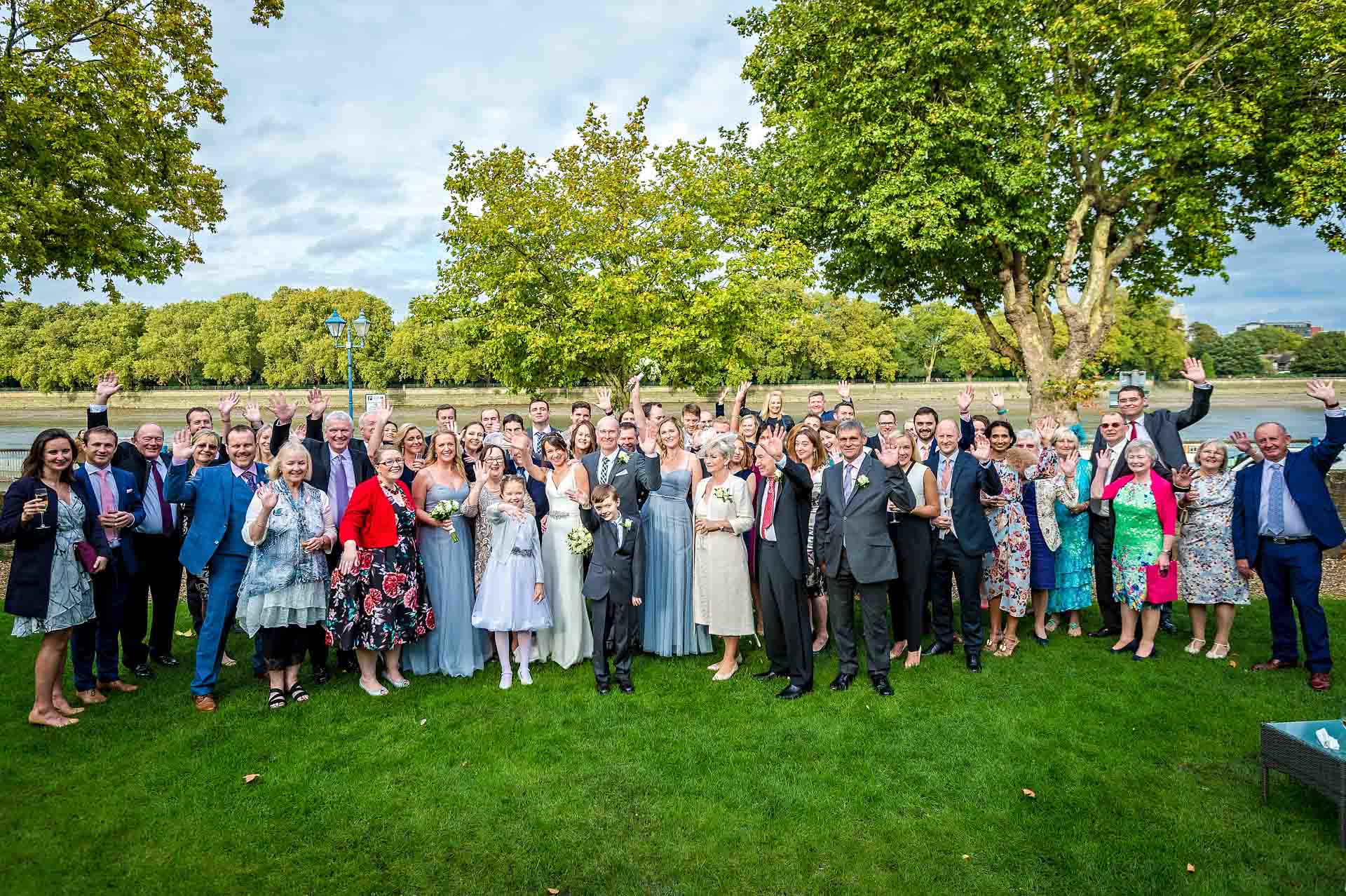 Group shot of everyone at a wedding in the garden of Winchester House in Putney