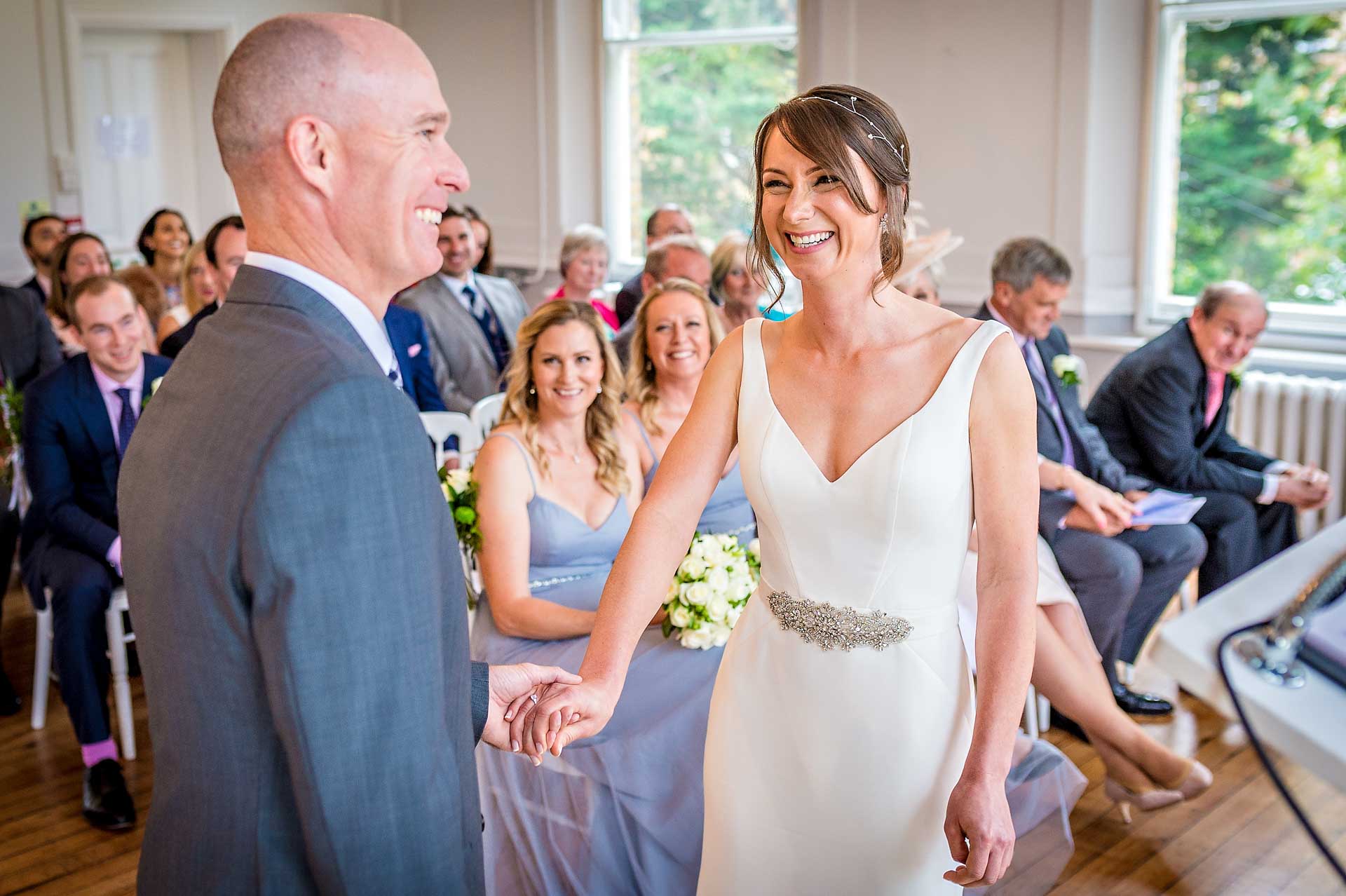 Bride laughing with groom at wedding ceremony
