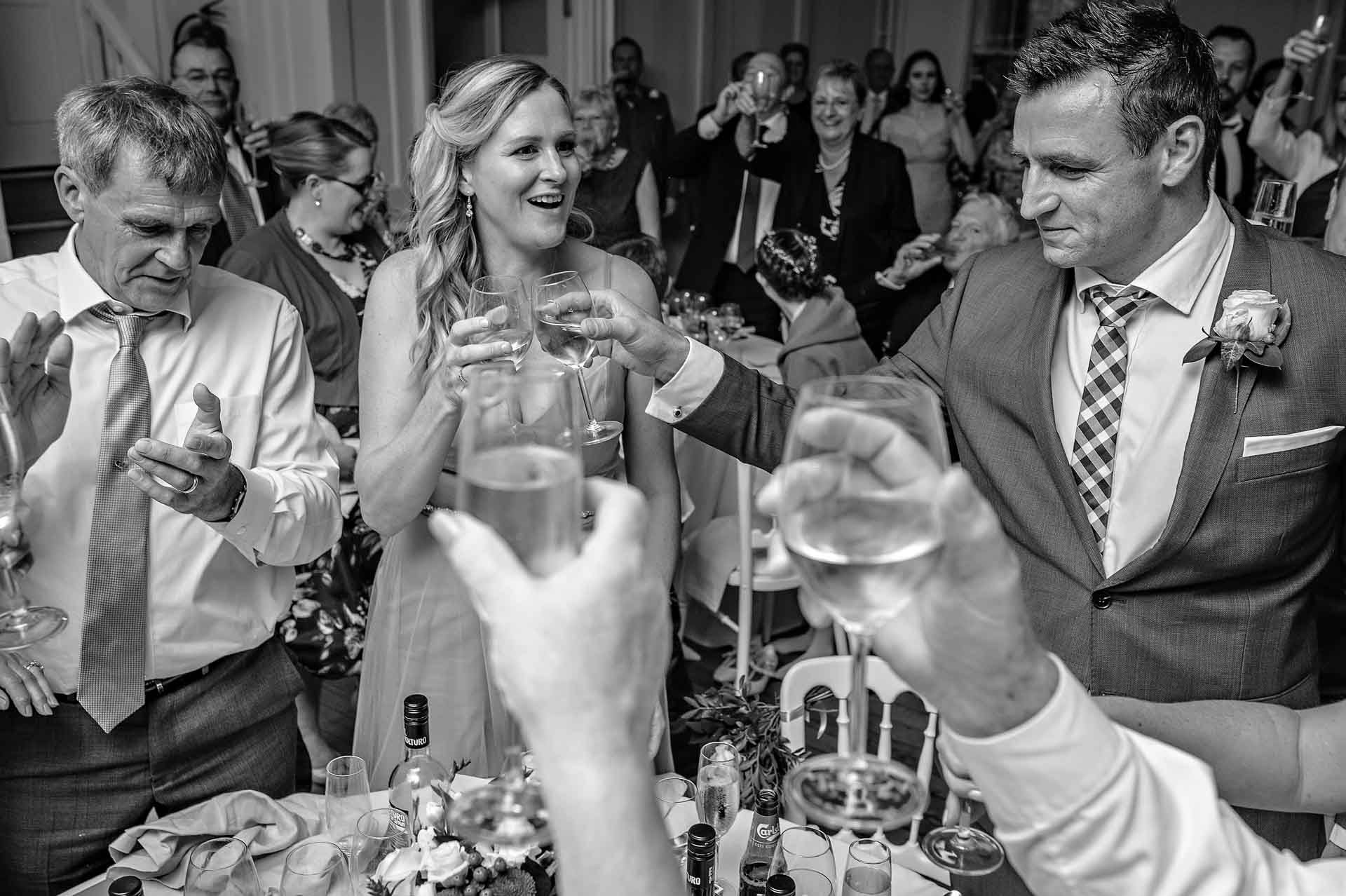 Guests clapping and clinking glasses together during toasts