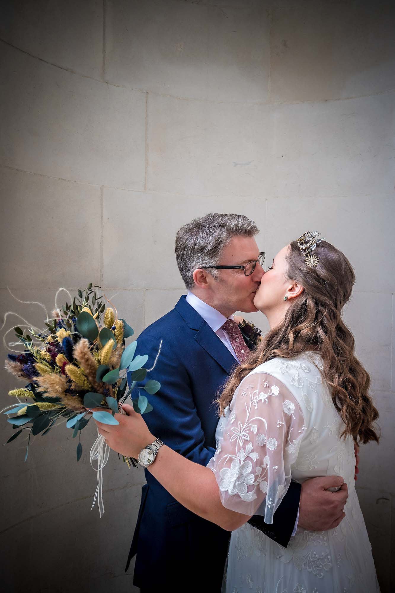 The newlyweds kiss after wedding in London