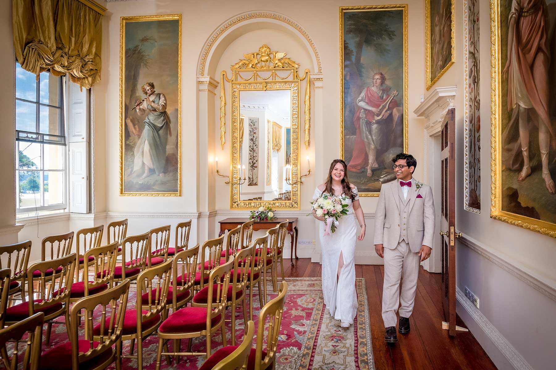 Newlyweds walk through the Dining Room at Danson House after their wedding.