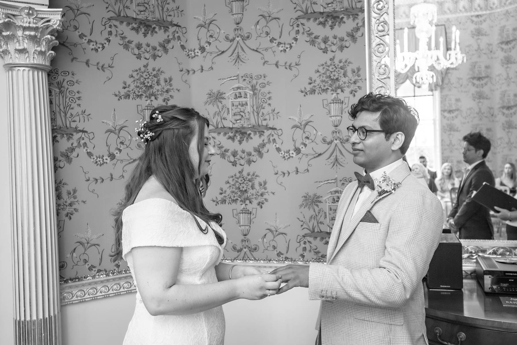 The bride places the ring on her groom's finger at Bexley Register Office