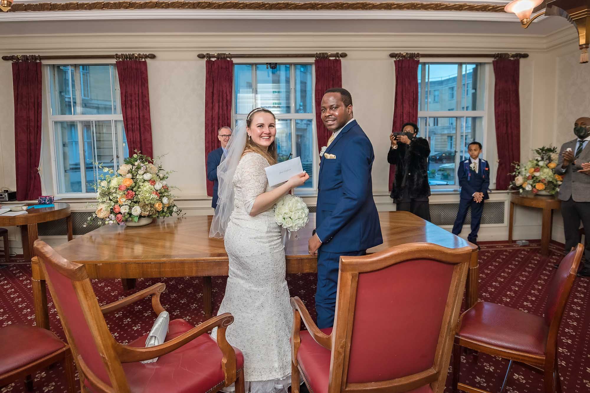 The newly-weds show off their marriage certificate at their Wandsworth Town Hall wedding