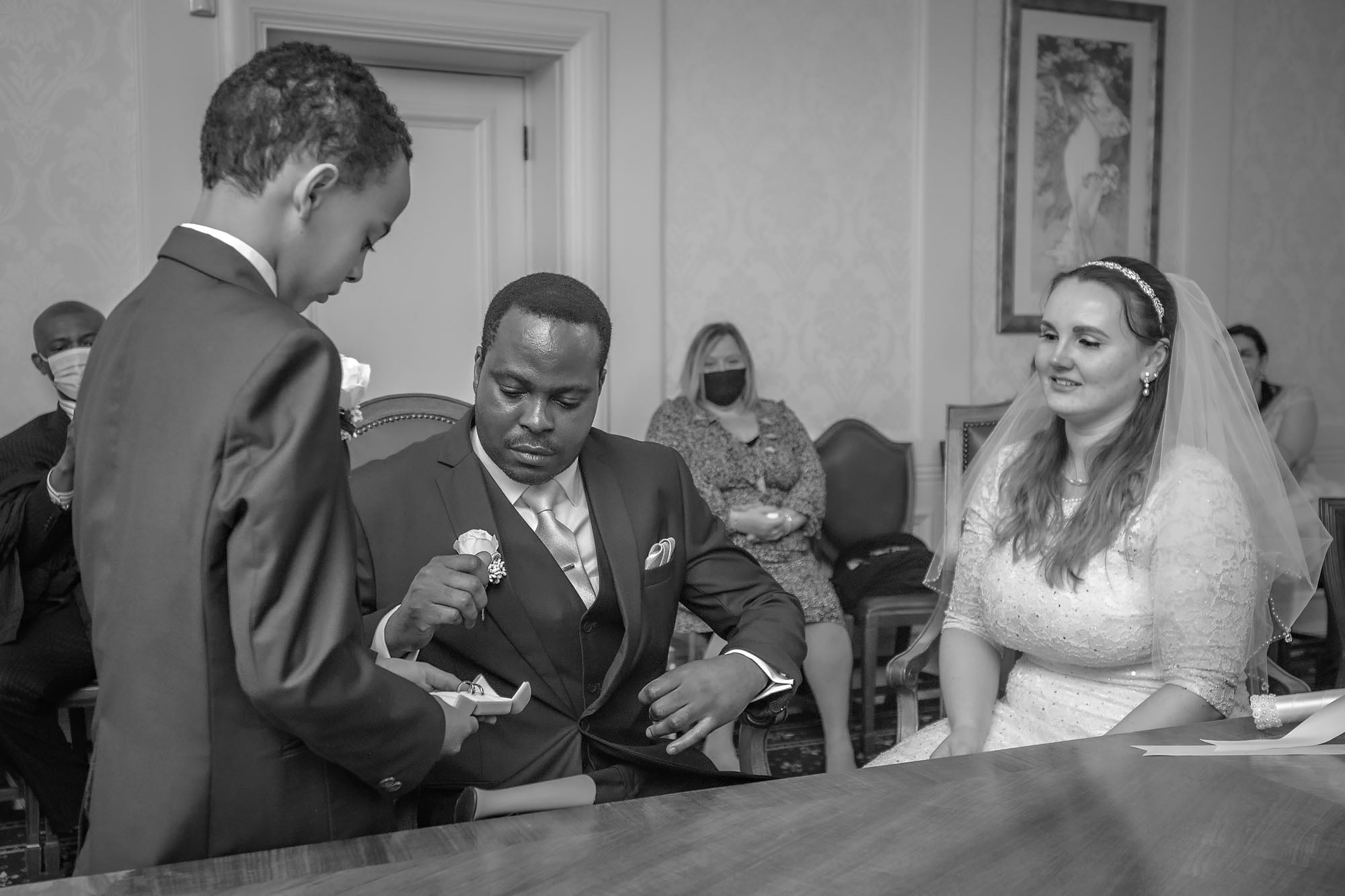 The couple's son presents the rings to the groom at Wandsworth Register Office's Victoria Room