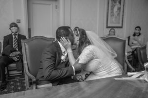 A tender touch as the bride holds her grooms face after their marriage ceremony
