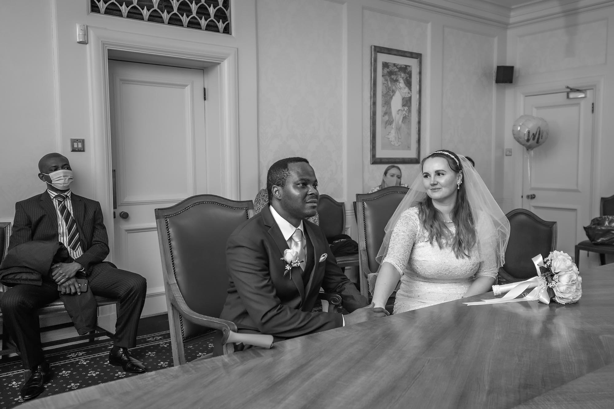 The bride gives her groom a loving look during their wedding at Wandsworth Town Hall