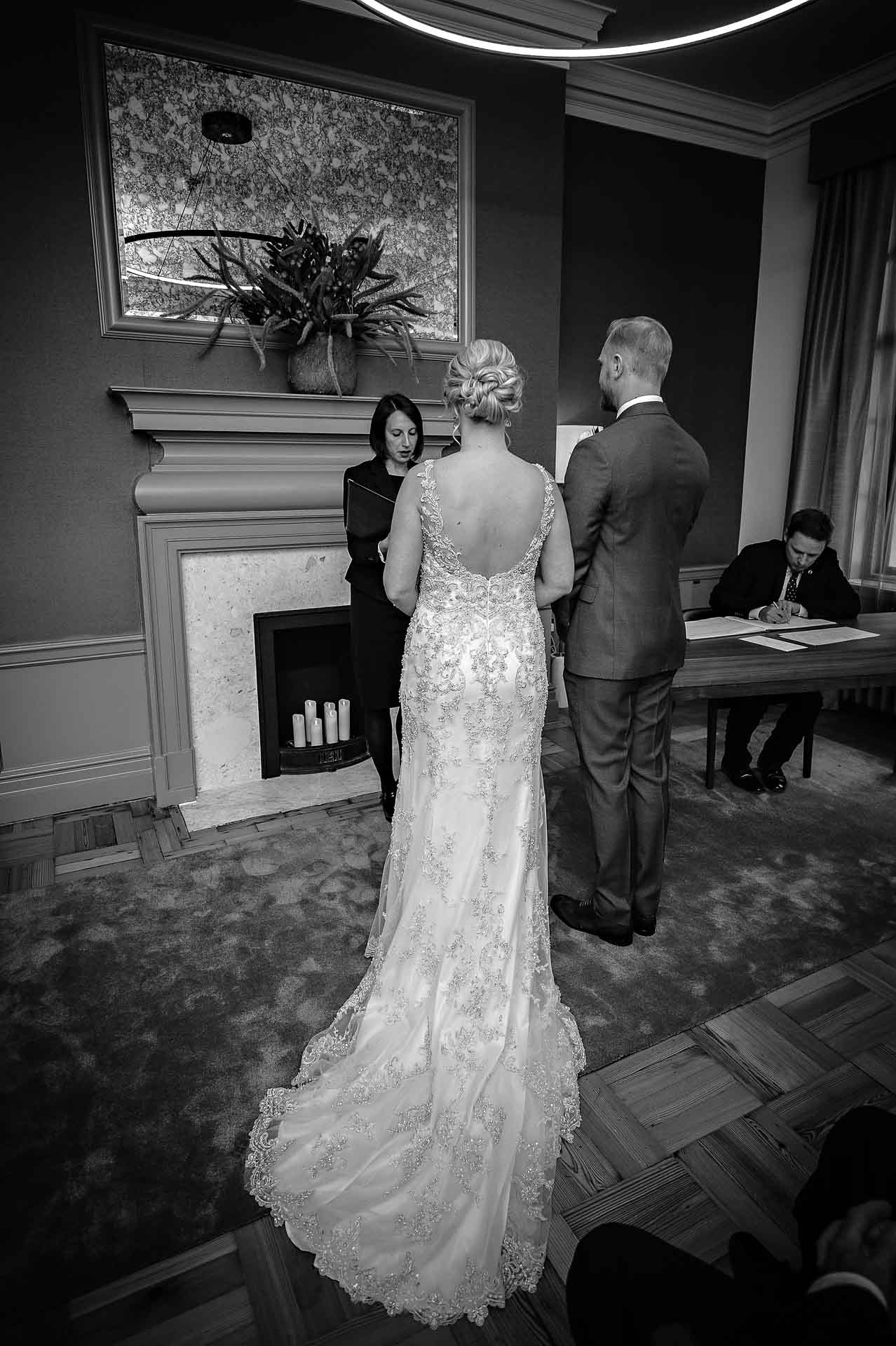 Back shot of bride and groom at wedding ceremony