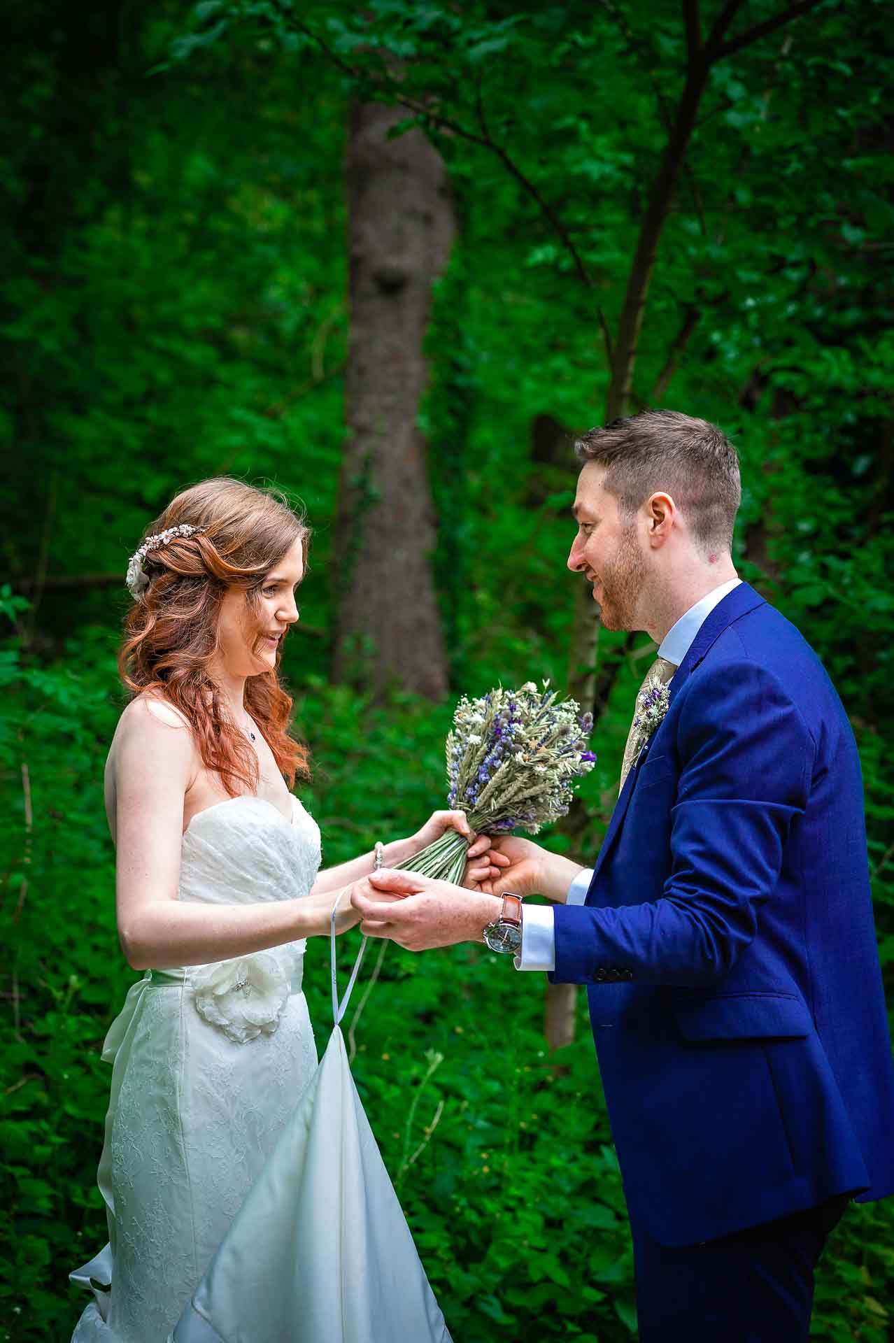 Bride and Groom Holding Hands with lavender bouquet