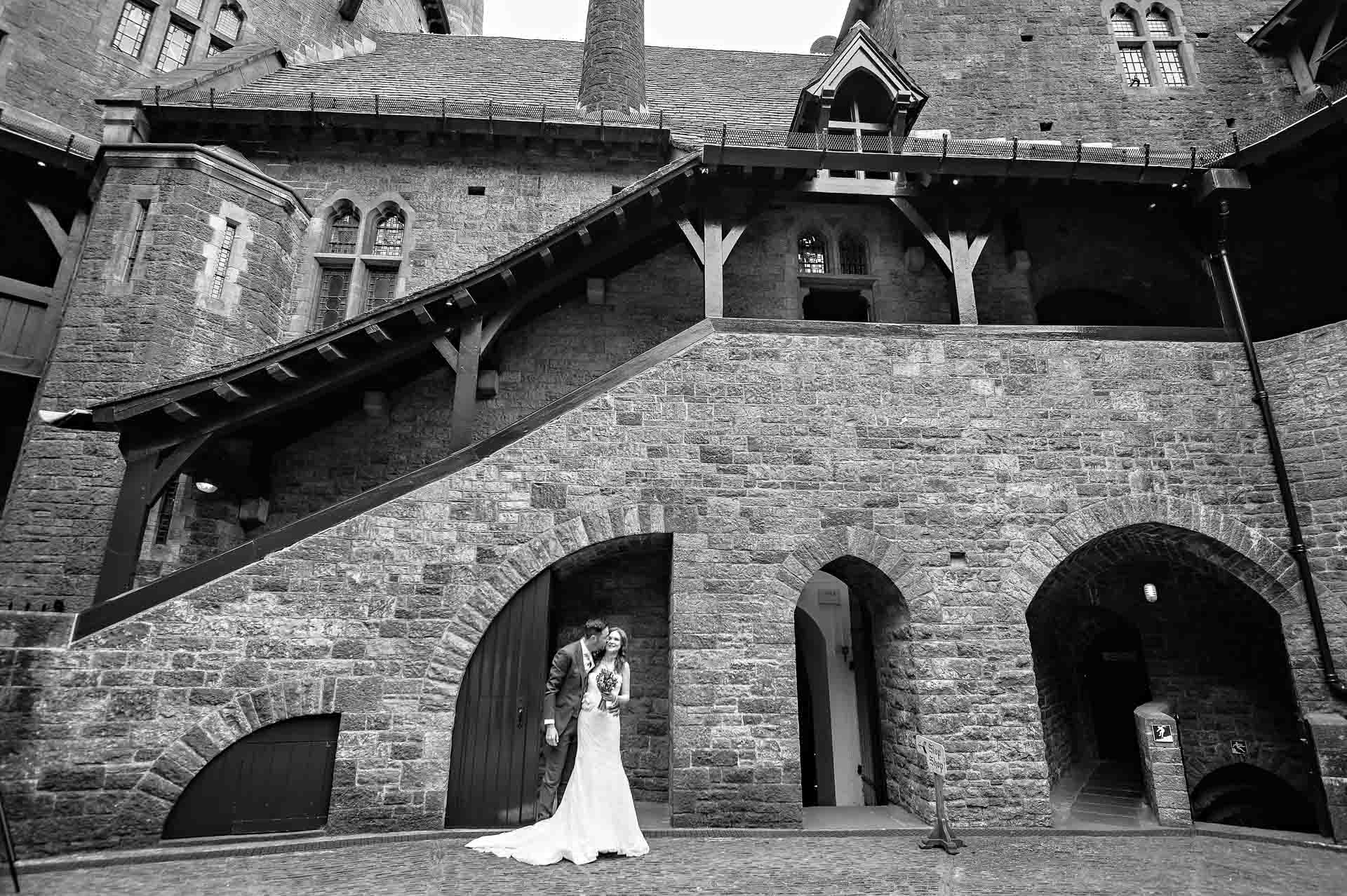 Wide shot of wedding couple in Castell Coch Courtyard