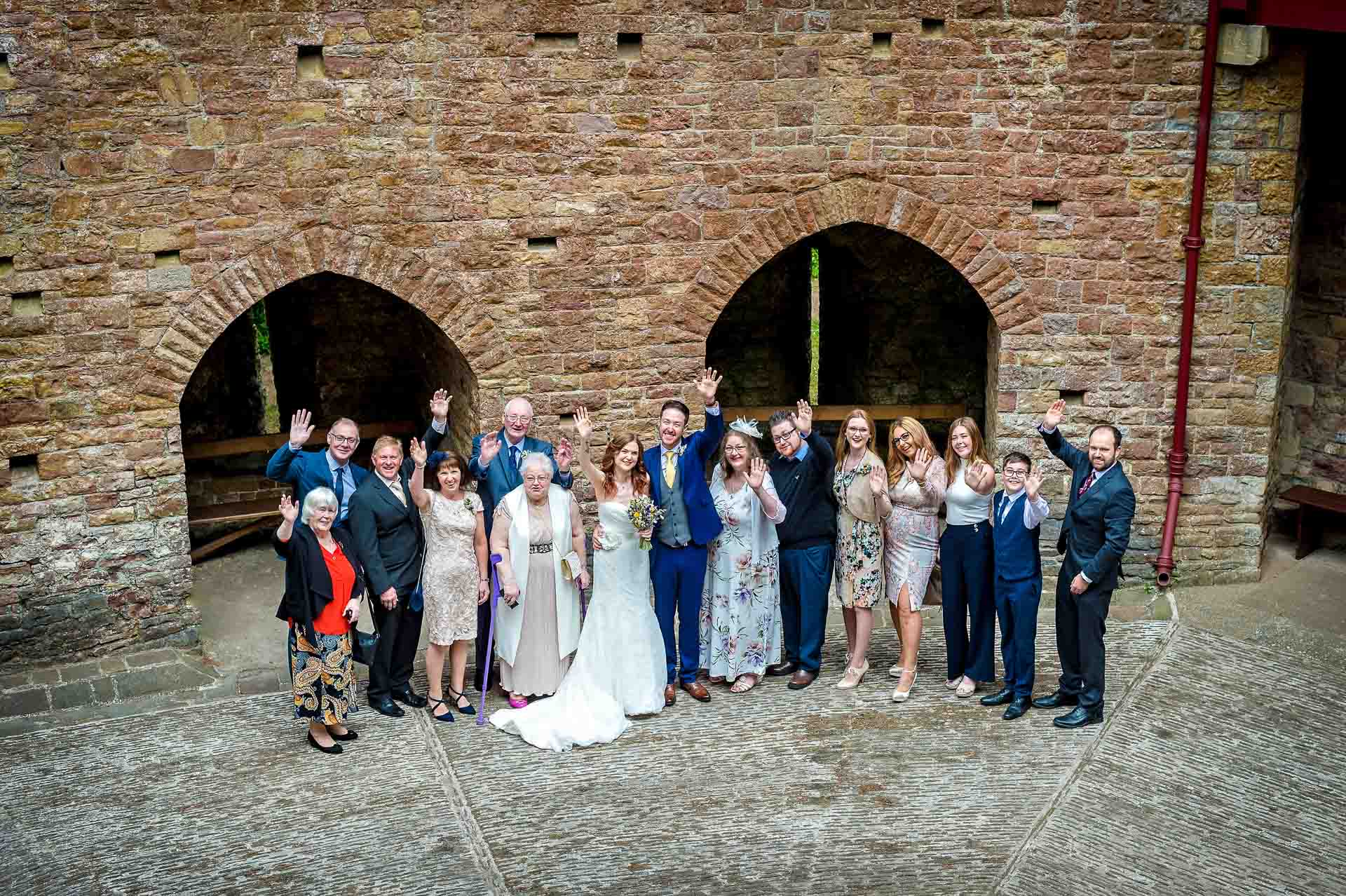 Group Posed Shot of Everyone at Castell Coch Wedding in Courtyard