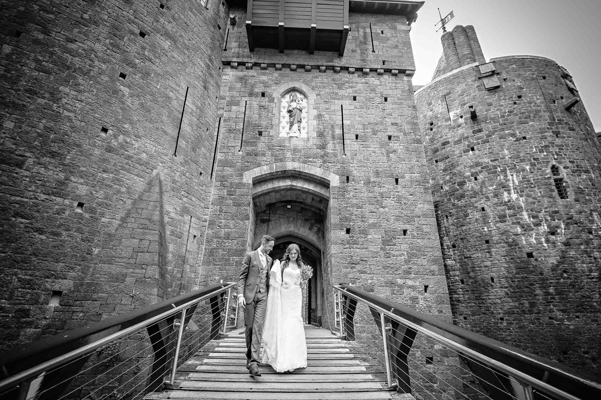 The newly-weds descend the drawbridge at Castell Coch wedding