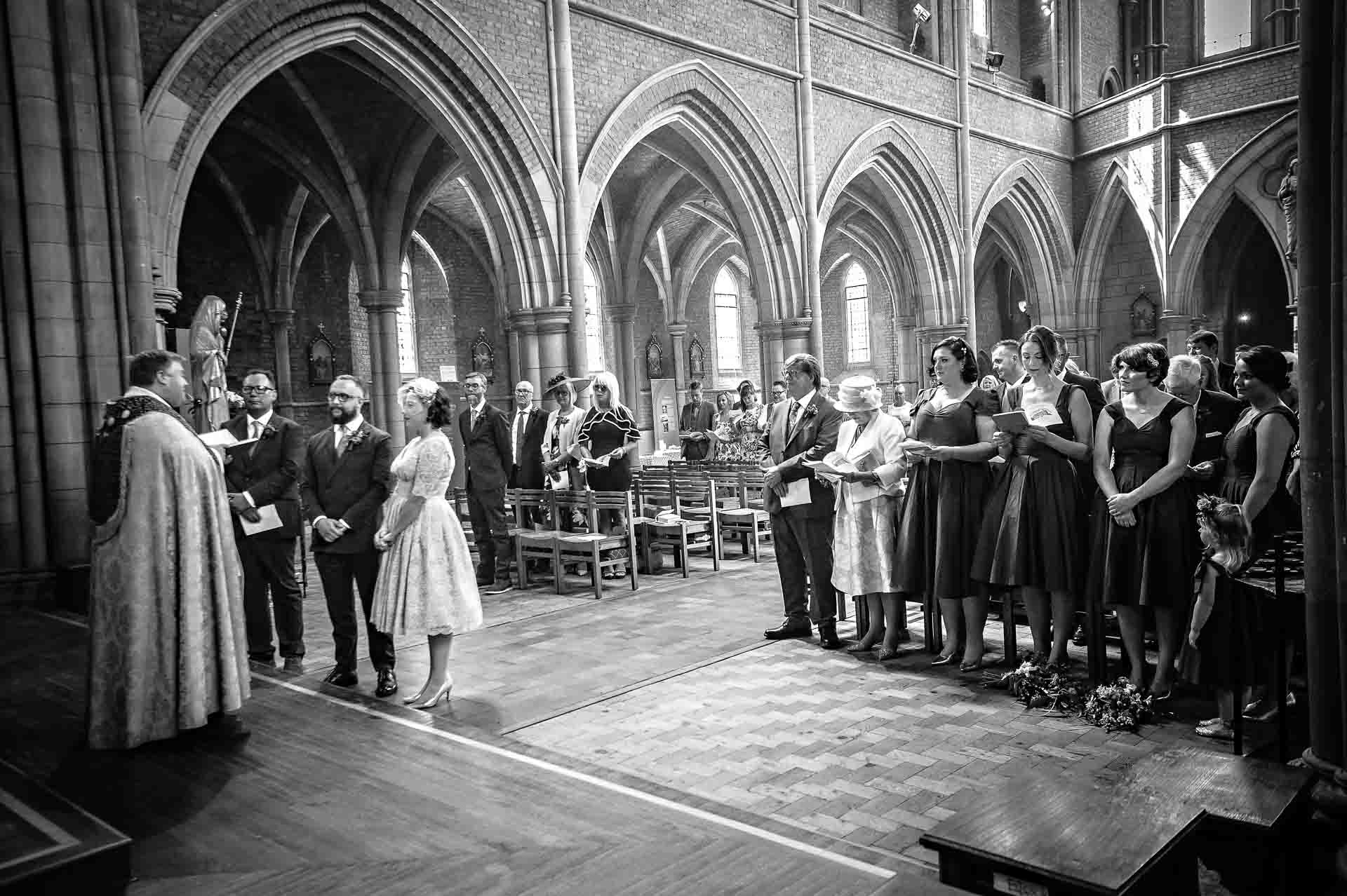 Church wedding ceremony and congregation in black and white