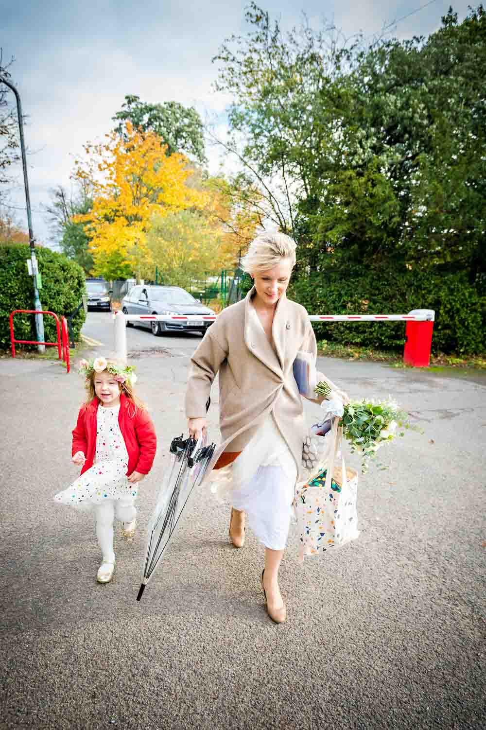 The bride and her daughter walk up the driveway to Morden Park house for her wedding