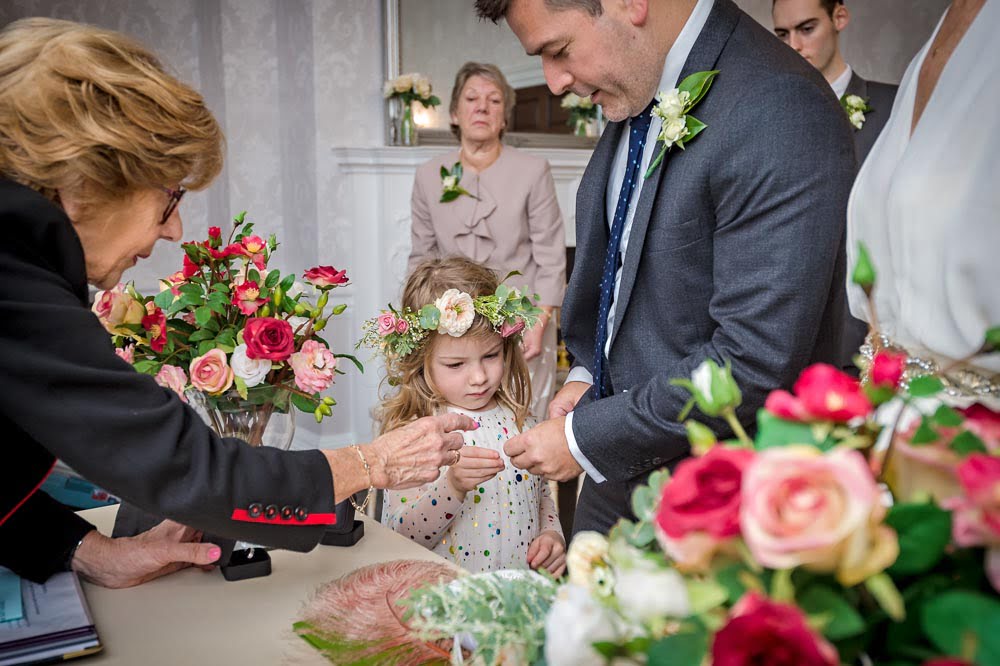 Little girl presenting the rings at Merton wedding in Morden Park House