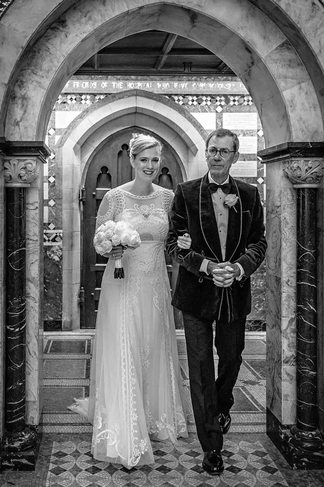 Bride with Father Walking Down the Aisle at a Wedding at the Fitzrovia Chapel