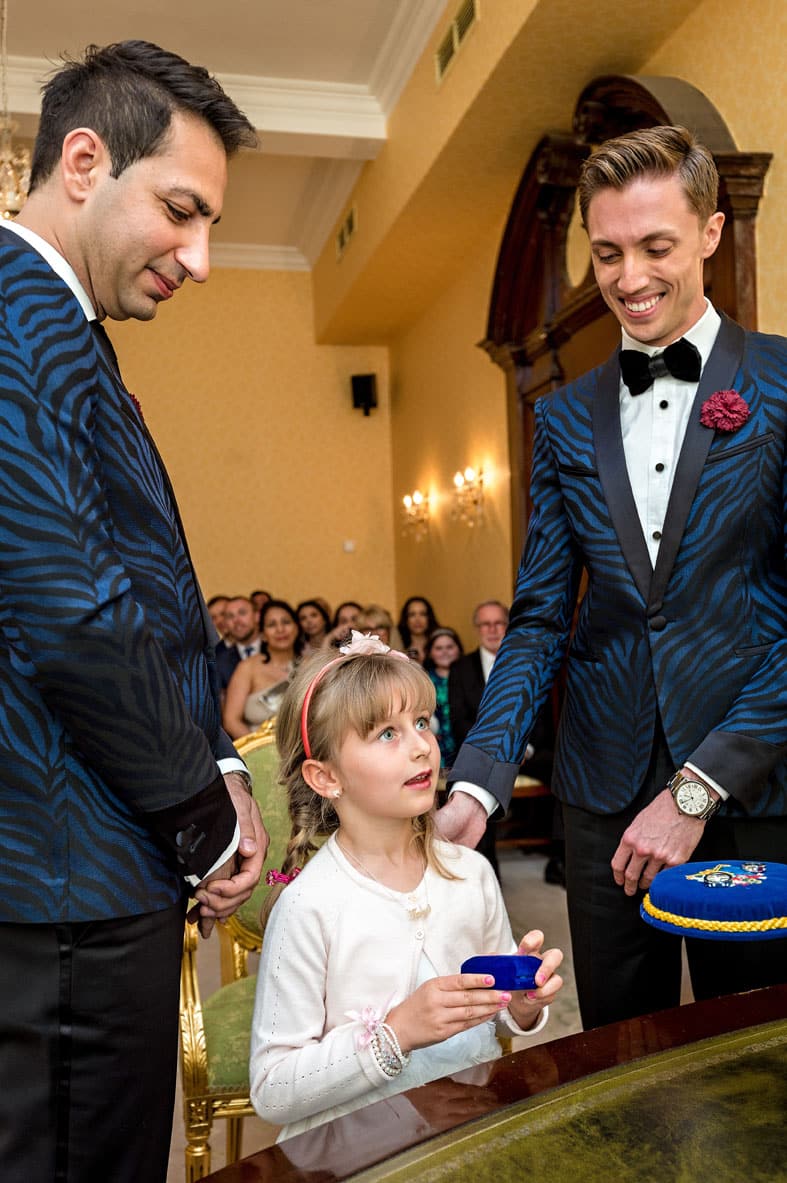 Small girl presenting rings at Chelsea Old Town Hall wedding in London