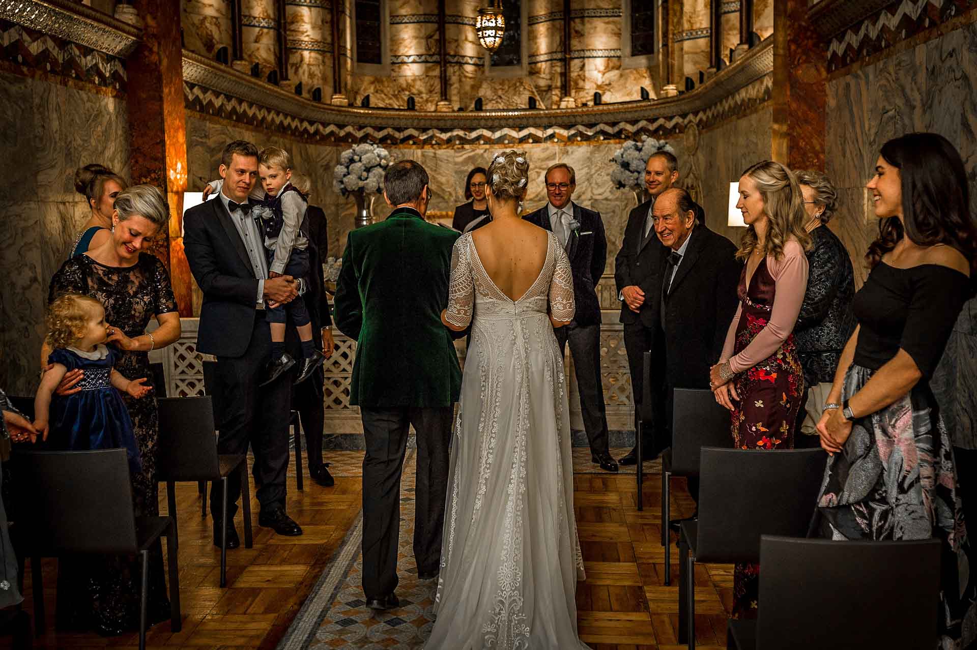 The bride's father escorts her down the aisle at the Fitzrovia Chapel