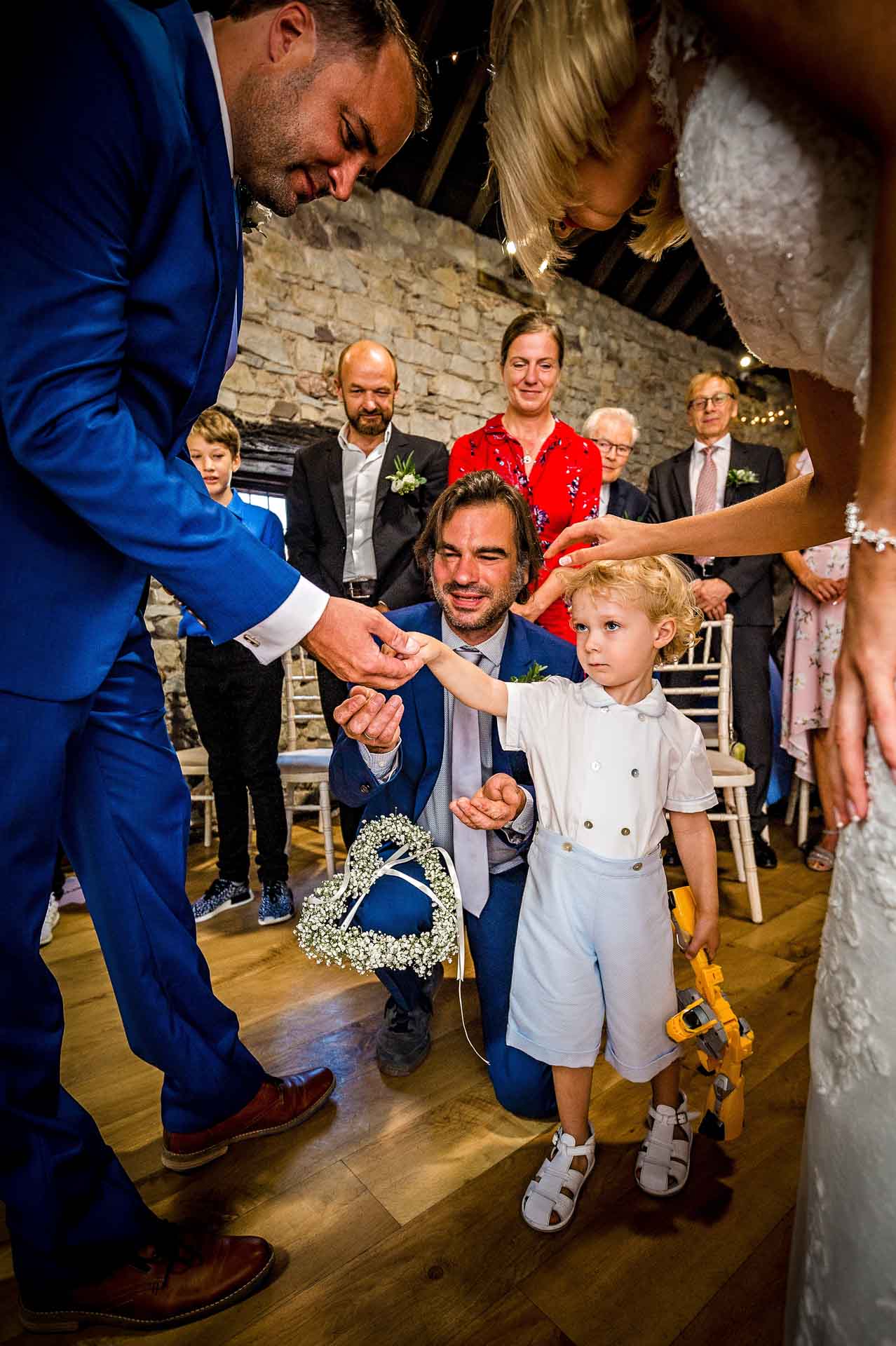 Little boy giving the couple rings at Pencoed House, Cardiff wedding