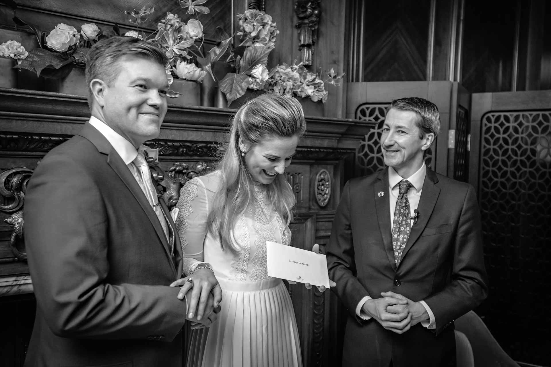 Couple being presented with wedding certificate at Westminster Register Office
